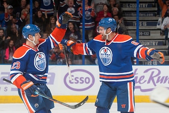 EDMONTON, AB - OCTOBER 24: Matt Hendricks #23 and Jesse Joensuu #6 of the Edmonton Oilers celebrate after scoring a goal against the Carolina Hurricanes on October 24, 2014 at Rexall Place in Edmonton, Alberta, Canada. (Photo by Andy Devlin/NHLI via Getty