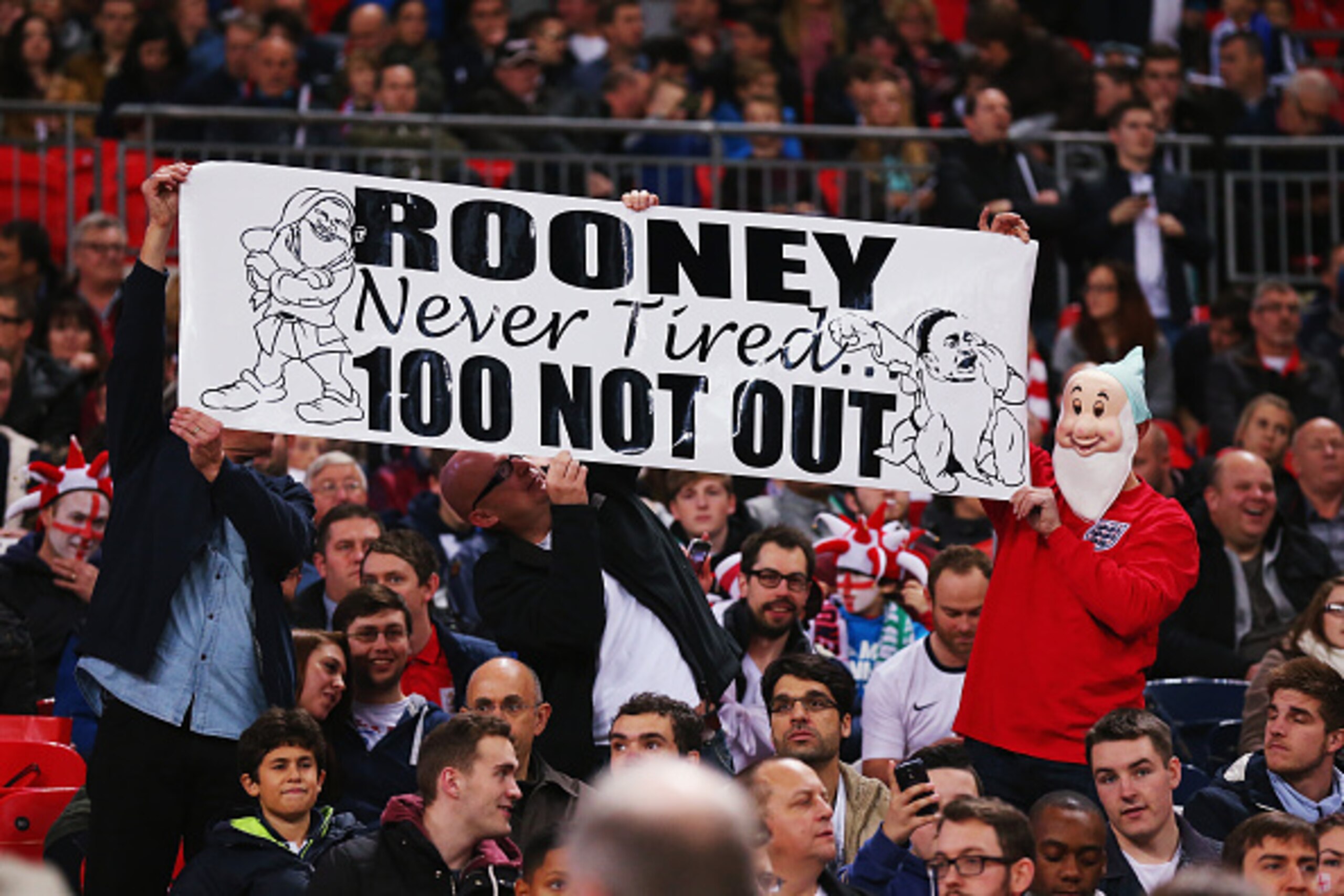 LONDON, ENGLAND - NOVEMBER 15: England fans hold up a banner marking Wayne Rooney's 100th cap during the EURO 2016 Qualifier Group E match between England and Slovenia at Wembley Stadium on November 15, 2014 in London, England.  (Photo by Alex Livesey/Get