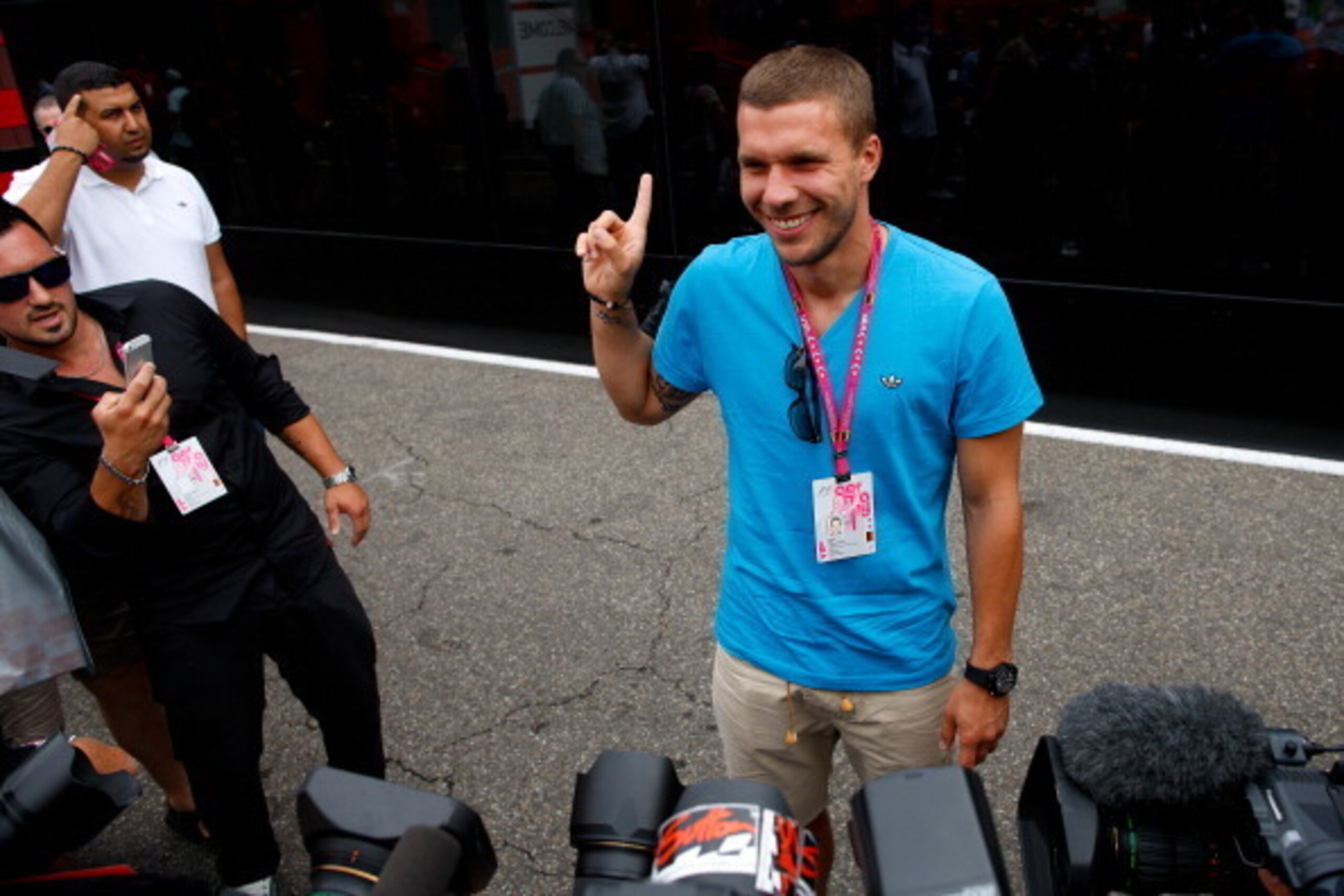 HOCKENHEIM, GERMANY - JULY 20:  Footballer Lukas Podolski of Germany and Arsenal poses in the paddock as he arrives for the German Grand Prix at Hockenheimring on July 20, 2014 in Hockenheim, Germany.  (Photo by Drew Gibson/Getty Images)