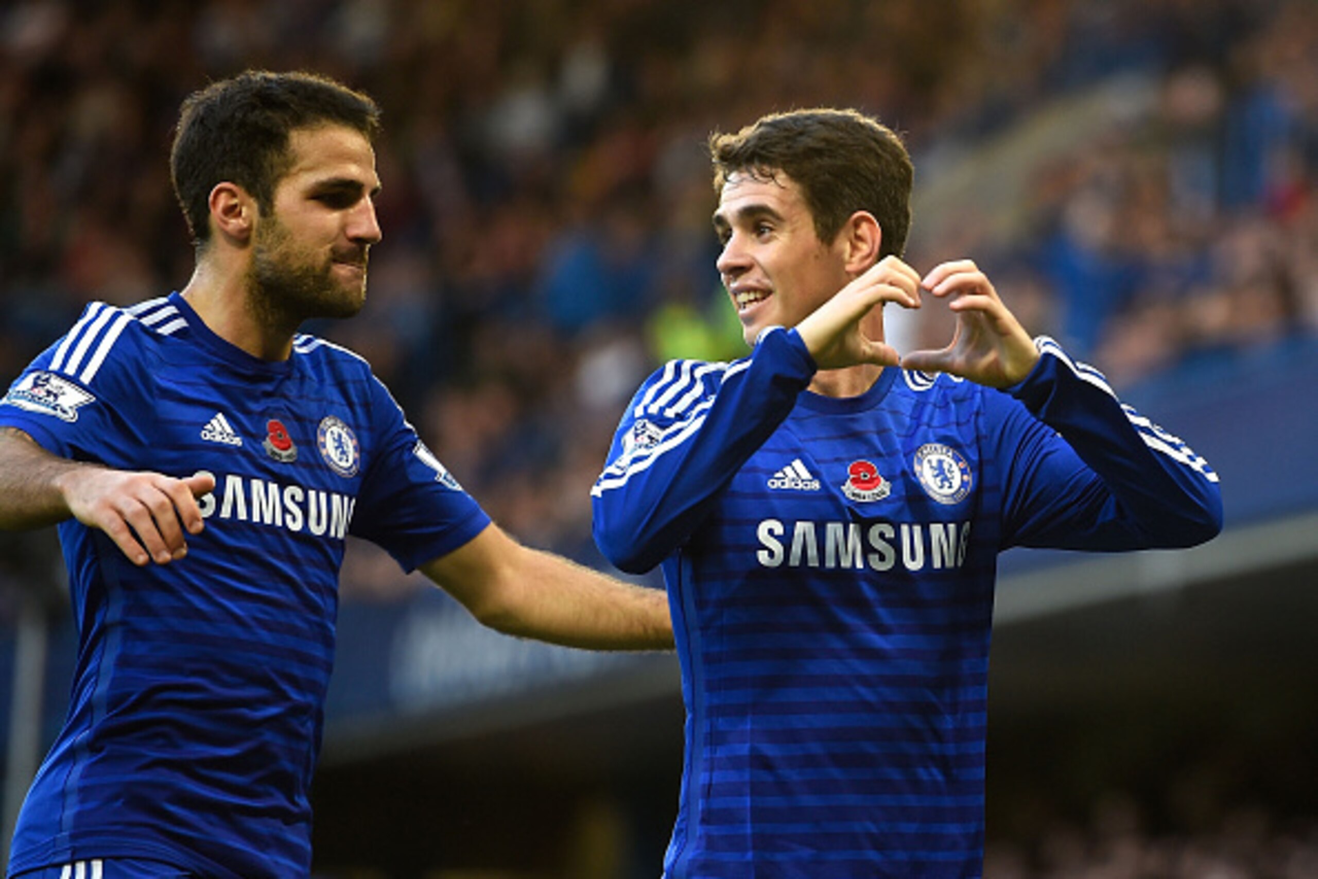 LONDON, ENGLAND - NOVEMBER 01:  Oscar of Chelsea celebrates his goal with Cesc Fabregas during the Barclays Premier League match between Chelsea and Queens Park Rangers at Stamford Bridge on November 1, 2014 in London, England.  (Photo by Mike Hewitt/Gett