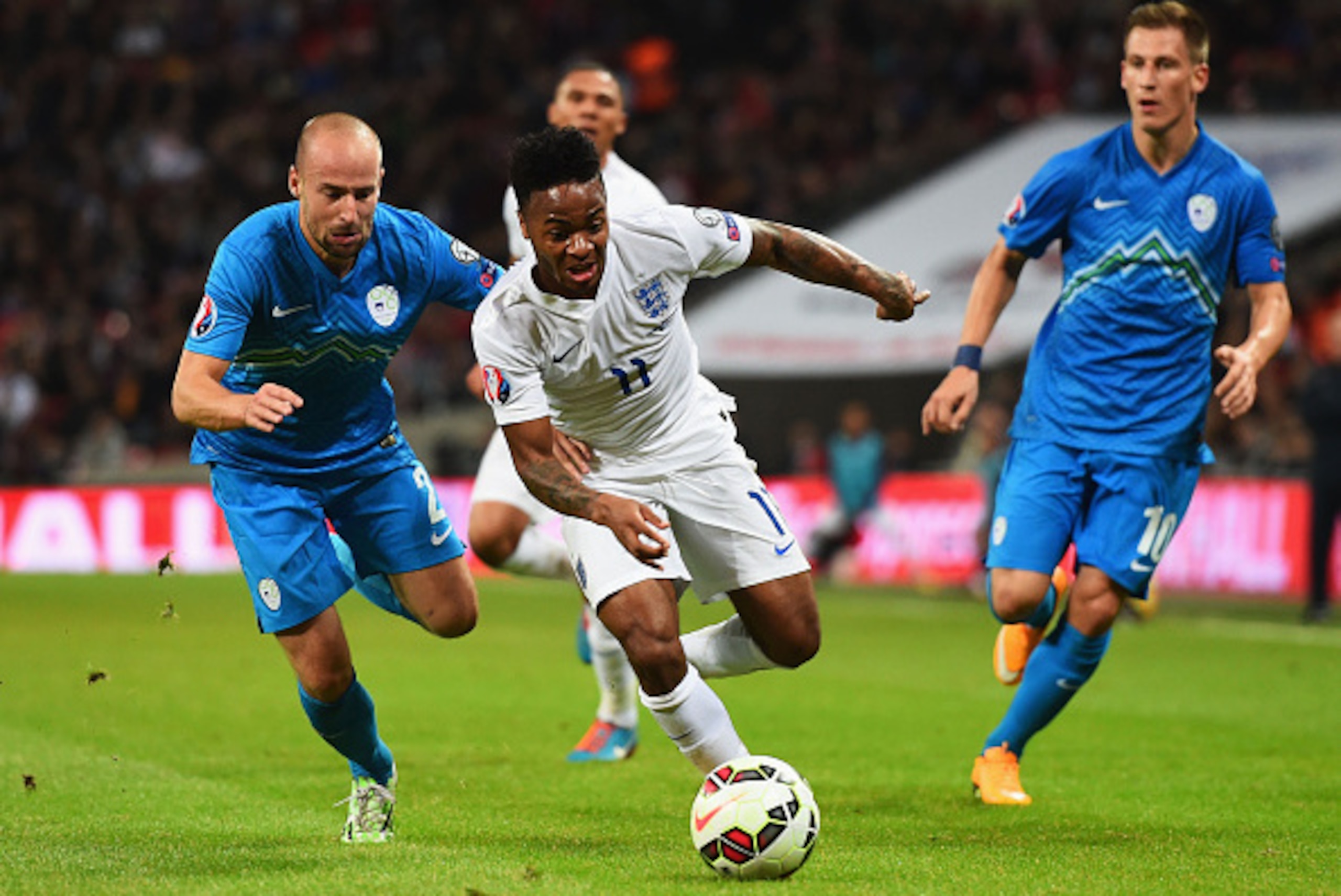 LONDON, ENGLAND - NOVEMBER 15:  Raheem Sterling of England is chased by Miso Brecko of Slovenia (L) during the EURO 2016 Qualifier Group E match between England and Slovenia at Wembley Stadium on November 15, 2014 in London, England.  (Photo by Shaun Bott