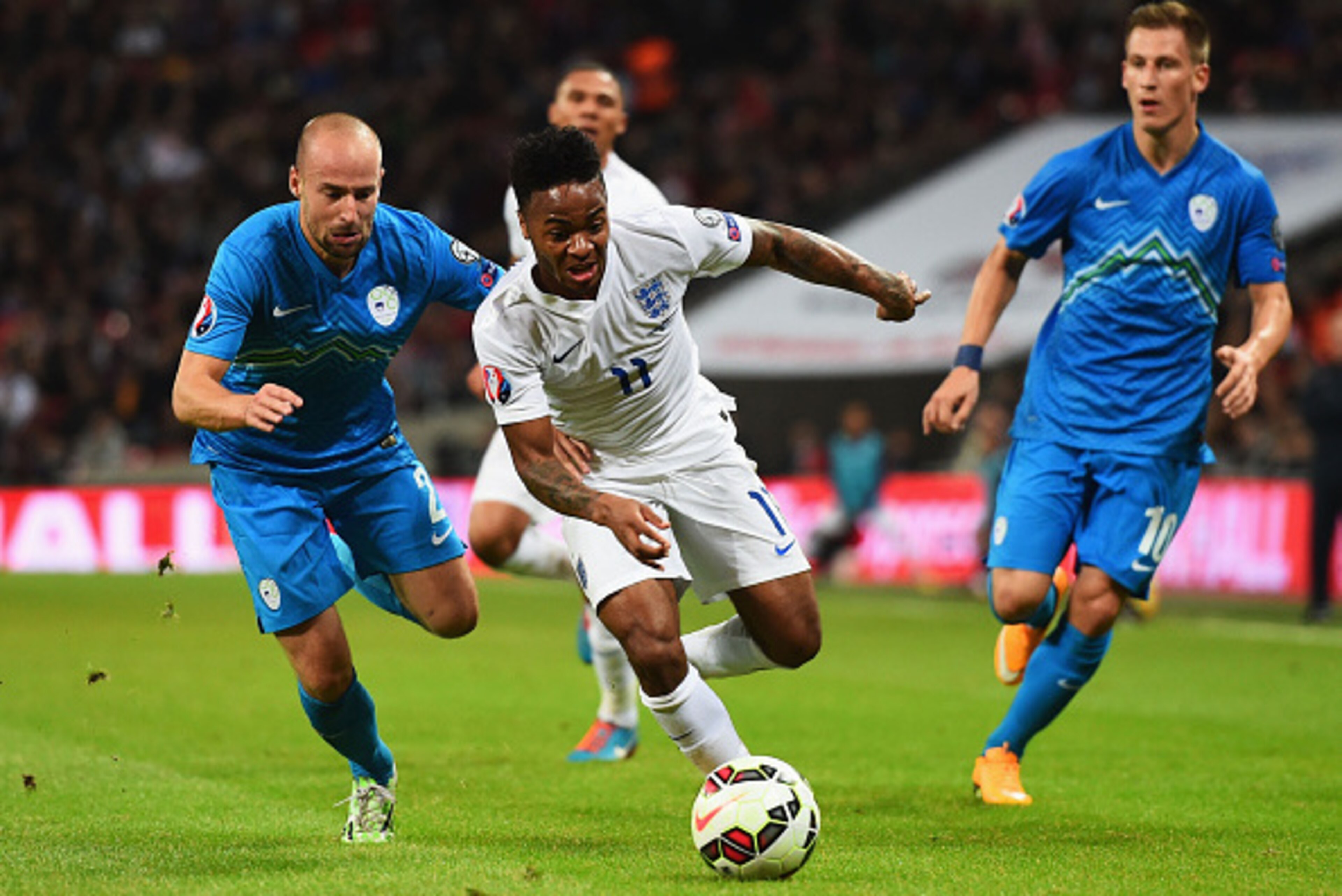 LONDON, ENGLAND - NOVEMBER 15:  Raheem Sterling of England is chased by Miso Brecko of Slovenia (L) during the EURO 2016 Qualifier Group E match between England and Slovenia at Wembley Stadium on November 15, 2014 in London, England.  (Photo by Shaun Bott