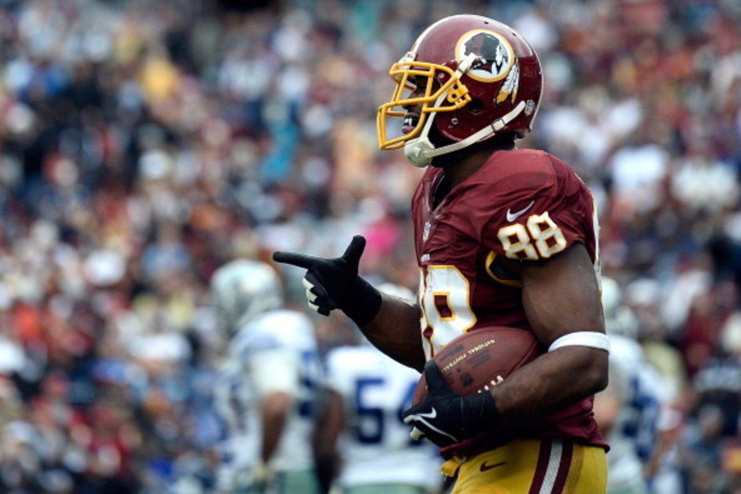 LANDOVER, MD - DECEMBER 22:  Pierre Garcon #88 of the Washington Redskins celebrates after scoring a touchdown in the third quarter during an NFL game against the Dallas Cowboys at FedExField on December 22, 2013 in Landover, Maryland.  (Photo by Patrick 