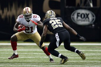NEW ORLEANS, LA - NOVEMBER 09:  Frank Gore #21 of the San Francisco 49ers is pursued by Rafael Bush #25 of the New Orleans Saints during the second quarter of a game at the Mercedes-Benz Superdome on November 9, 2014 in New Orleans, Louisiana.  (Photo by 