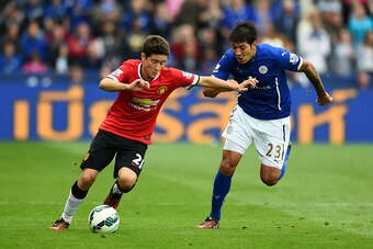 LEICESTER, ENGLAND - SEPTEMBER 21:  Ander Herrera of Manchester United challenged by Leonardo Ulloa of Leicester City during the Barclays Premier League match between Leicester City and Manchester United at The King Power Stadium on September 21, 2014 in 
