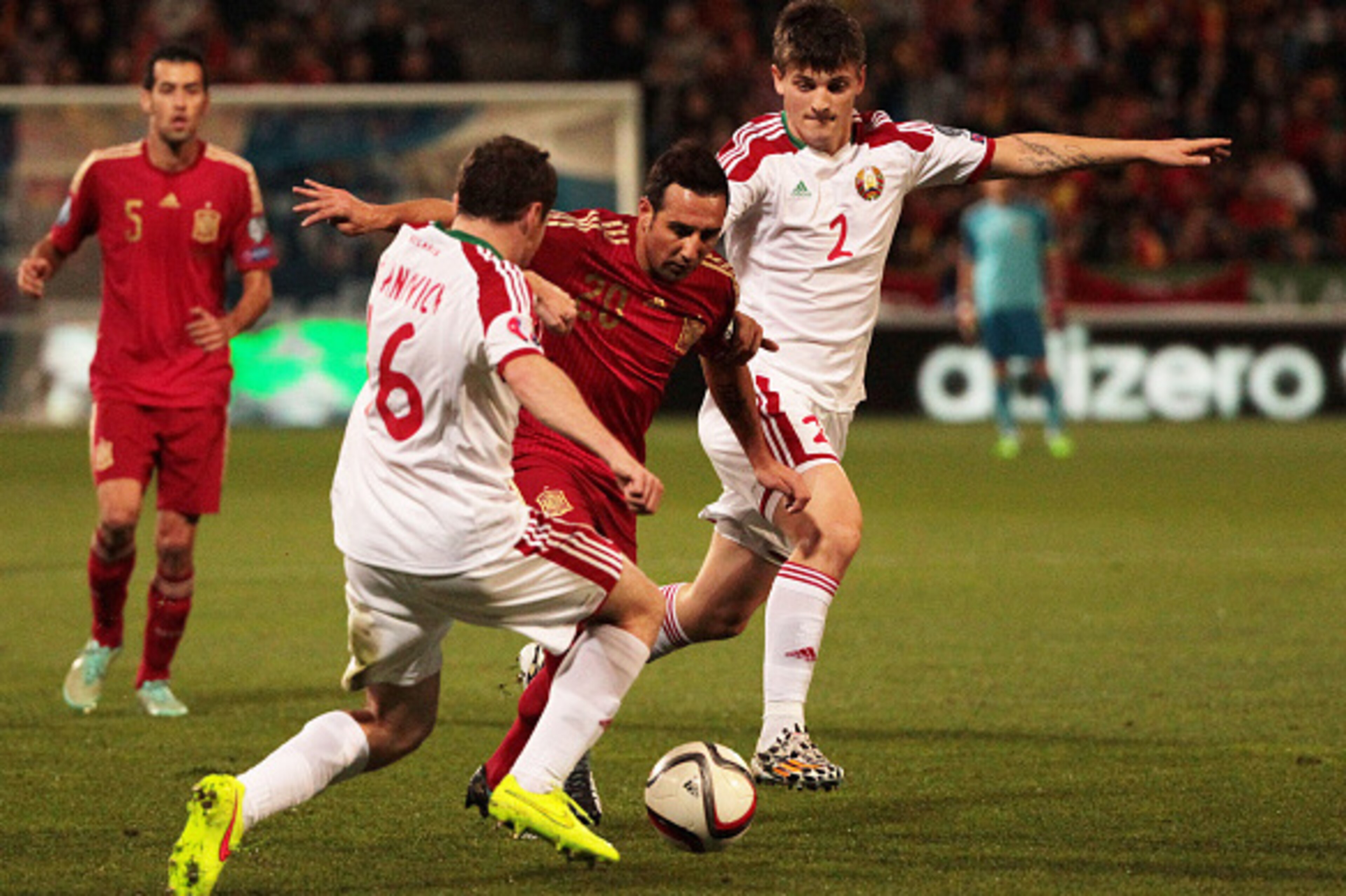 HUELVA, SPAIN - NOVEMBER 15: Santiago Cazorla of Spain (C) duels for the ball with Serguey Balanovich (L) and Stanislav Dragun of Belarus during the UEFA EURO 2016 Group C Qualifier football match between Spain and Belarus at Nuevo Colombino studium on No