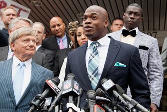 CONROE, TX - NOVEMBER 04:  Defense attorney Rusty Hardin, (L) and NFL running back Adrian Peterson of the of the Minnesota Vikings address the media after Peterson plead 'no contest' to a lesser misdemeanor charge of reckless assault on November 4, 2014 i