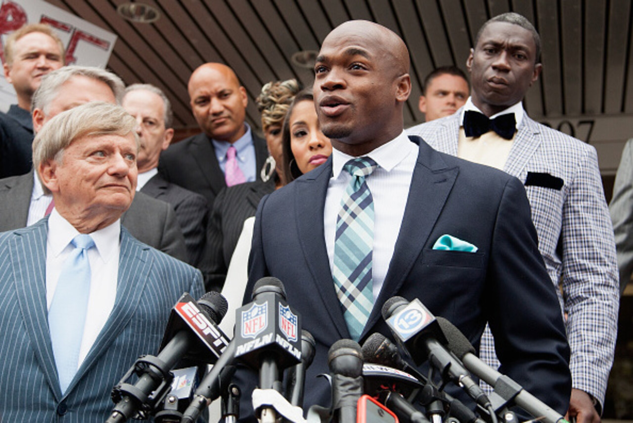 CONROE, TX - NOVEMBER 04:  Defense attorney Rusty Hardin, (L) and NFL running back Adrian Peterson of the of the Minnesota Vikings address the media after Peterson plead 'no contest' to a lesser misdemeanor charge of reckless assault on November 4, 2014 i