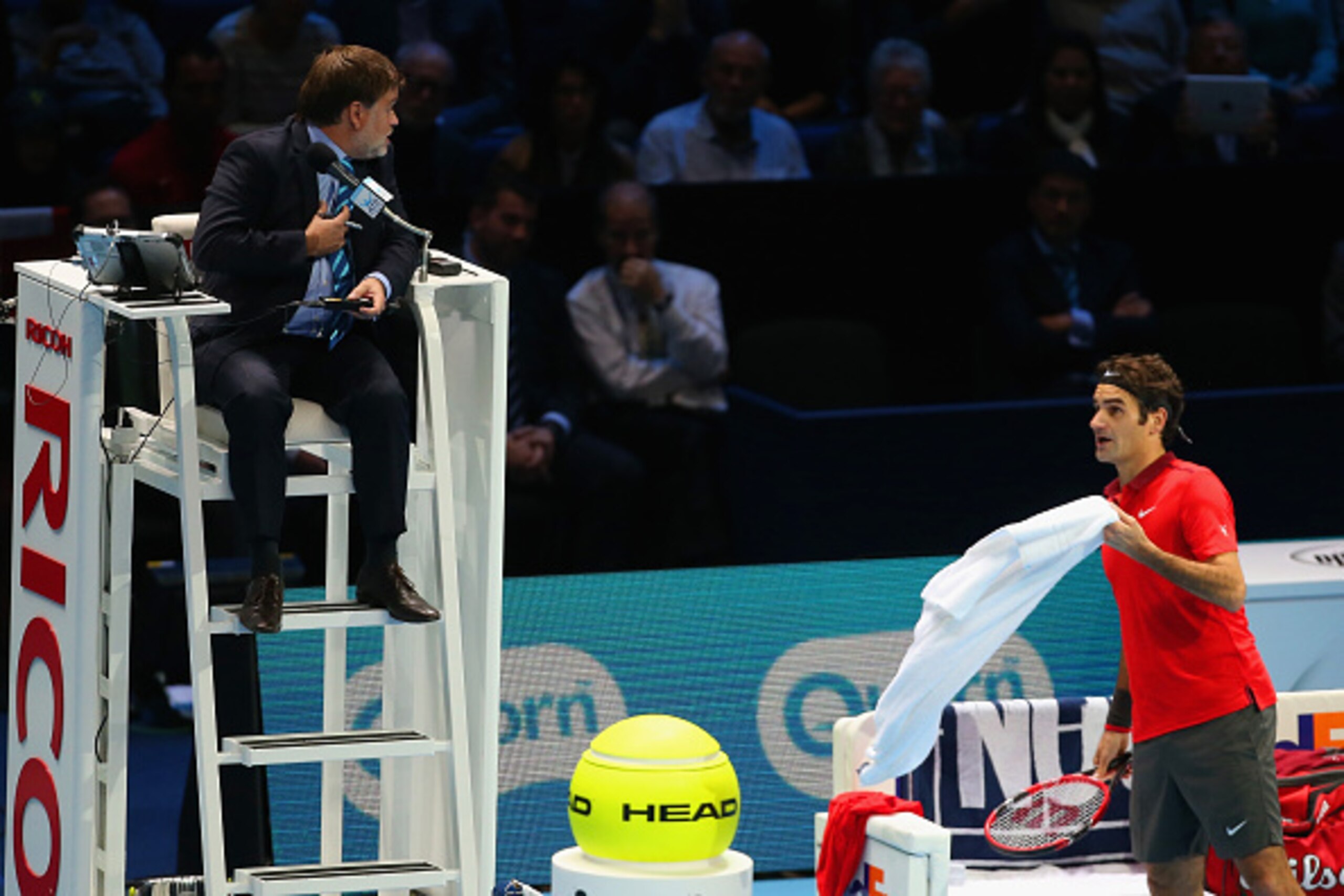 LONDON, ENGLAND - NOVEMBER 15:  Roger Federer of Switzerland speaks to umpire Cedric Mourier in the singles semi-final match against Stan Wawrinka of Switzerland on day seven of the Barclays ATP World Tour Finals at O2 Arena on November 15, 2014 in London