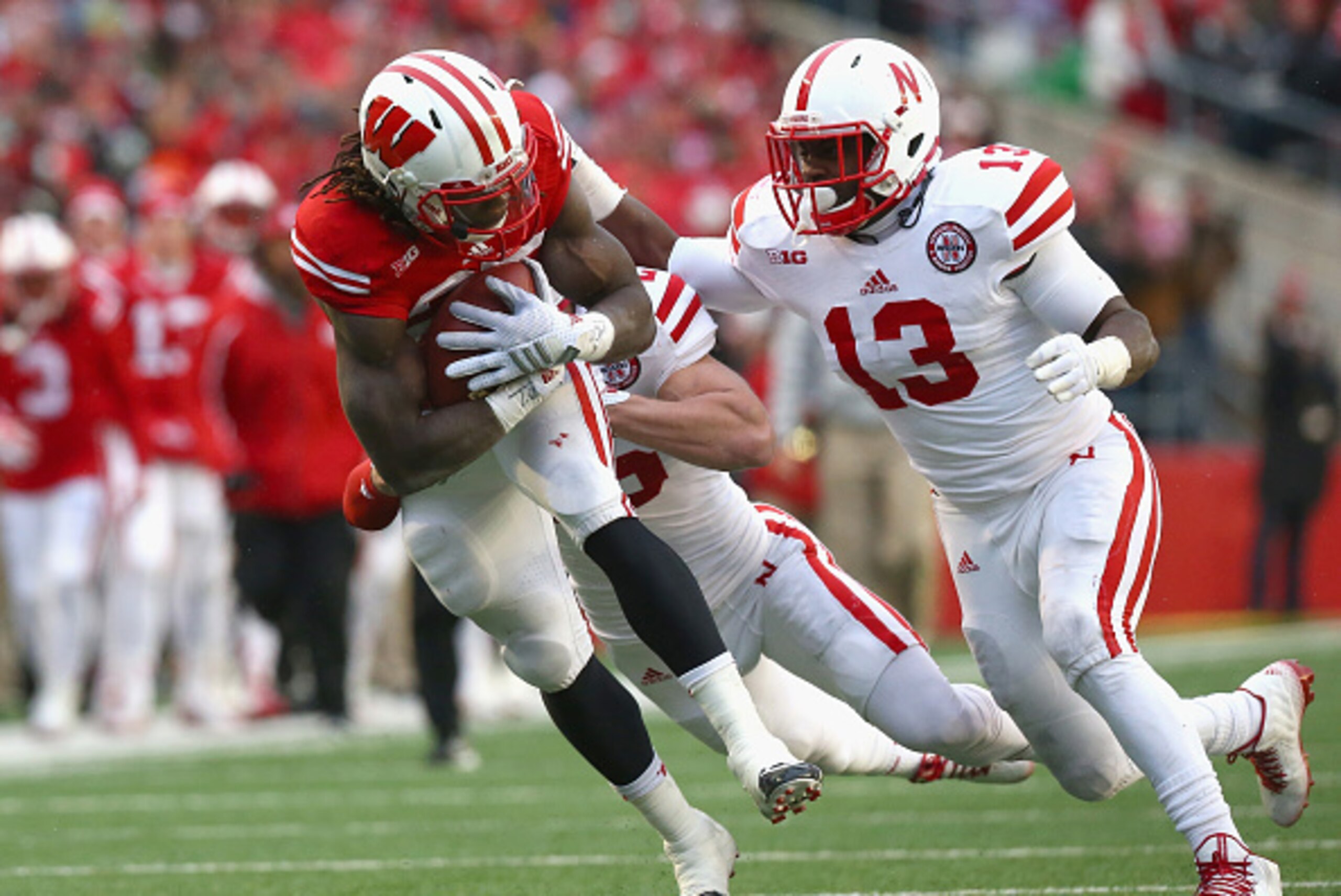 MADISON, WI - NOVEMBER 15:  Melvin Gordon #25 of the Wisconsin Badgers is tackled by Zaire Anderson #13 of the Nebraska Cornhuskers at Camp Randall Stadium on November 15, 2014 in Madison, Wisconsin.  (Photo by Ronald Martinez/Getty Images)