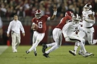 Nov 15, 2014; Tuscaloosa, AL, USA; Alabama Crimson Tide quarterback Blake Sims (6) carries the ball past Mississippi State Bulldogs defensive lineman Preston Smith (91) and Will Redmond (2) in the fourth quarter at Bryant-Denny Stadium. Mandatory Credit: 