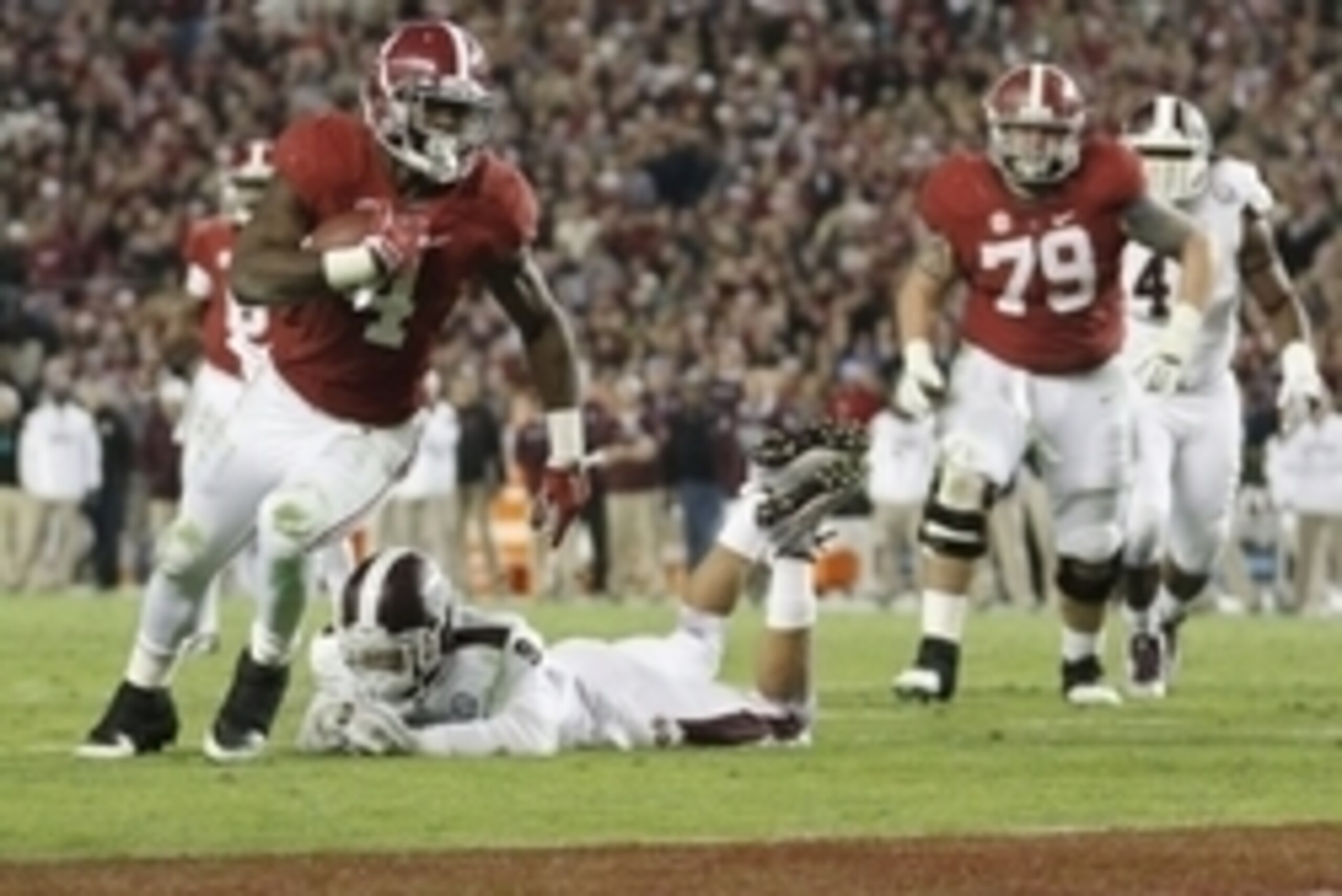 Nov 15, 2014; Tuscaloosa, AL, USA; Alabama Crimson Tide running back T.J. Yeldon (4) carries the past Mississippi State Bulldogs defensive back Justin Cox (9) for a touchdown in the fourth quarter at Bryant-Denny Stadium. Mandatory Credit: Marvin Gentry-U