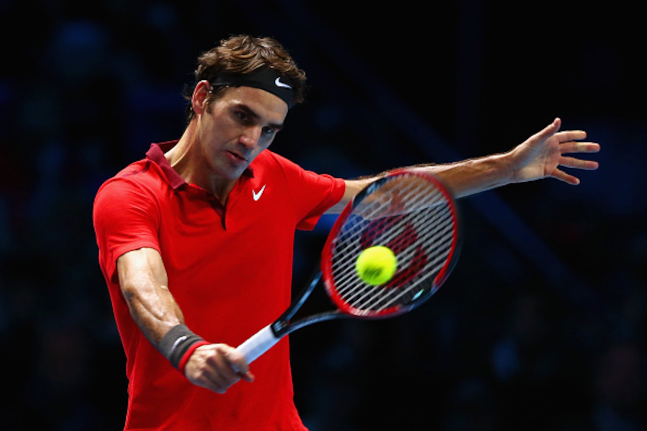 LONDON, ENGLAND - NOVEMBER 15:  Roger Federer of Switzerland plays a backhand in the singles semi-final match against Stan Wawrinka of Switzerland on day seven of the Barclays ATP World Tour Finals at O2 Arena on November 15, 2014 in London, England.  (Ph