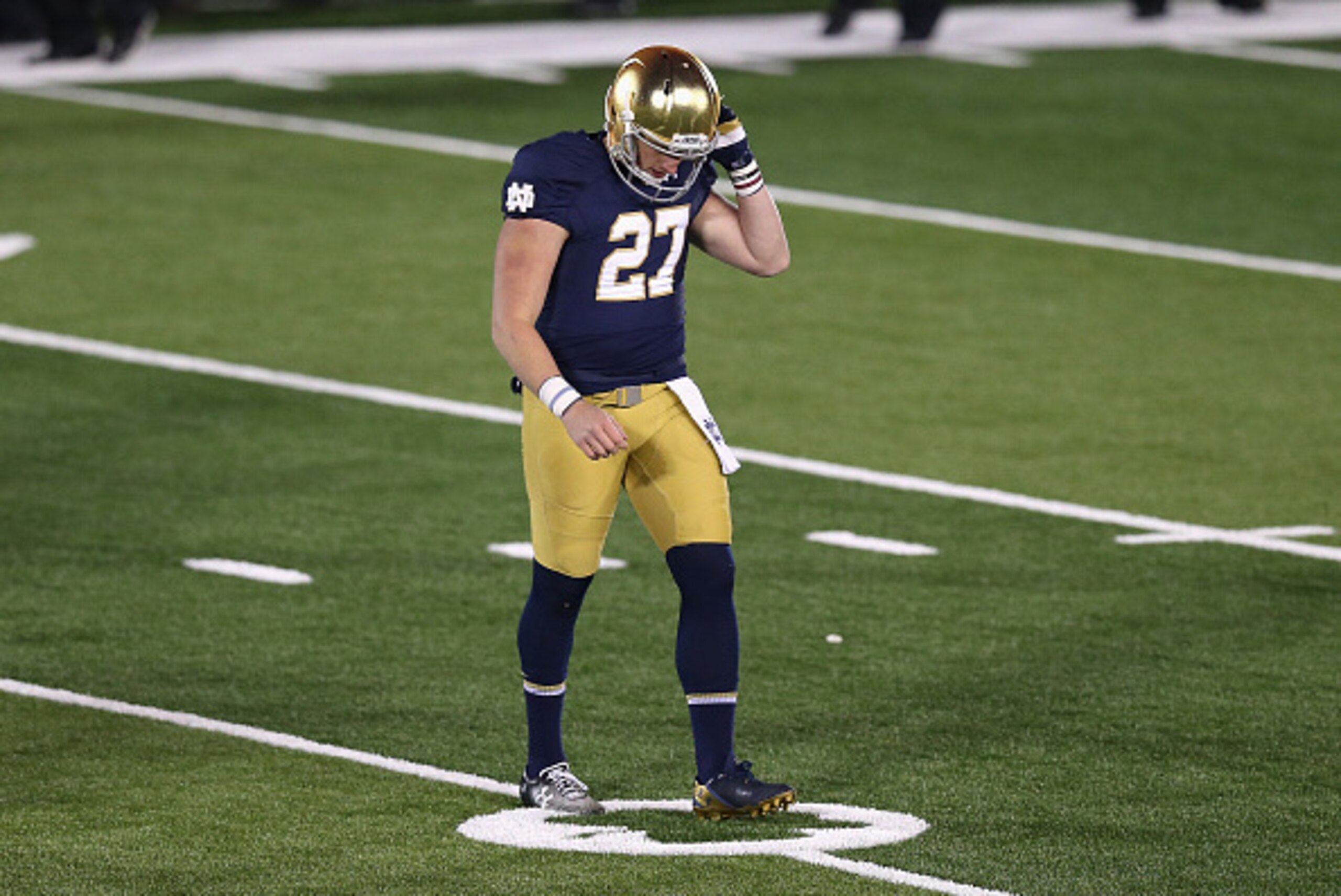 SOUTH BEND, IN - NOVEMBER 15: Kyle Brindza #27 of the Notre Dame Fighting Irish walks off of the field after missing a 42 yard field goal in overtime against the Northwestern Wildcats at Notre Dame Stadium on November 15, 2014 in South Bend, Indiana. Nort