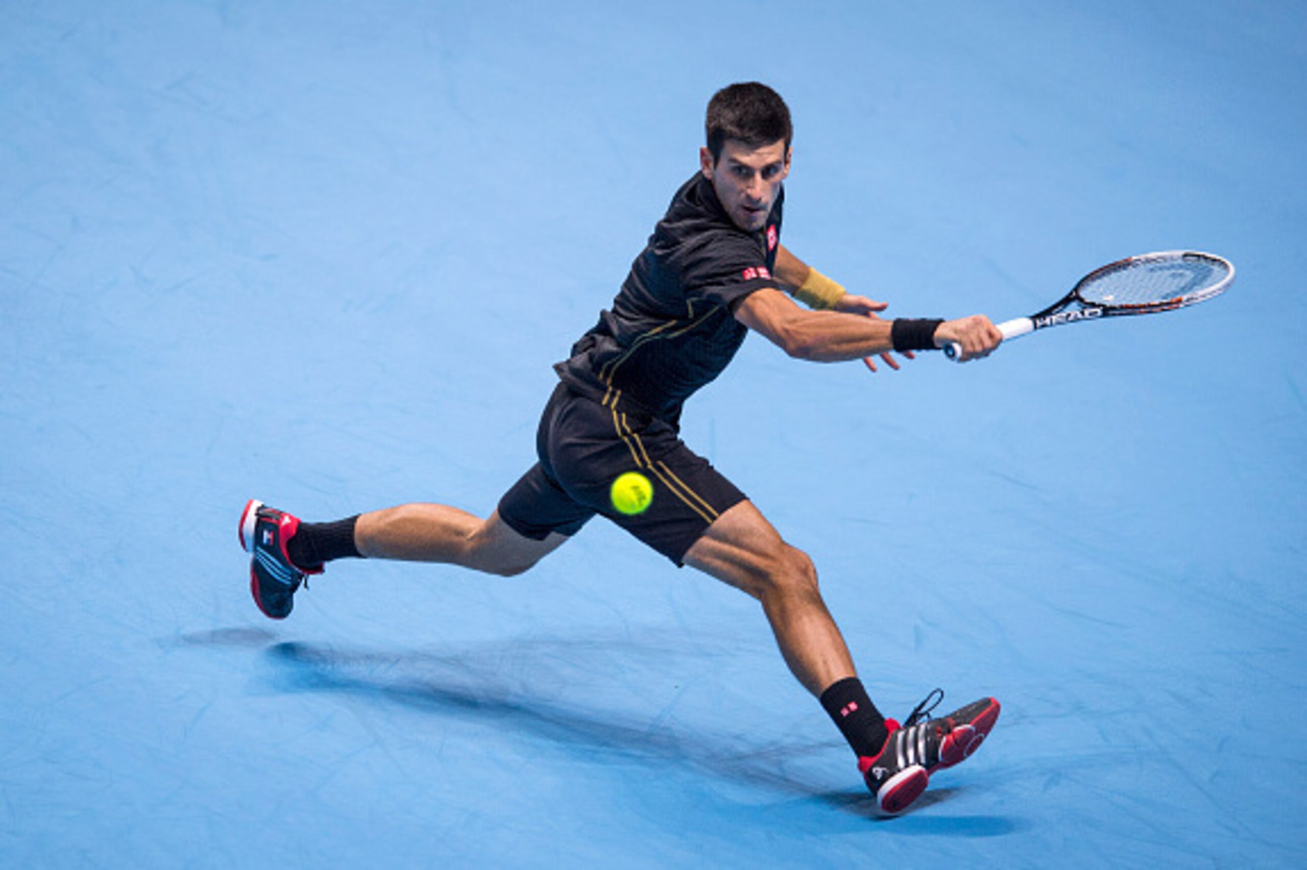 LONDON, ENGLAND - NOVEMBER 15:  Novak Djokovic of Serbia in action during the round robin singles match against Kei Nishikori of Japan on day seven of the Barclays ATP World Tour Finals at O2 Arena on November 15, 2014 in London, England.  (Photo by Justi