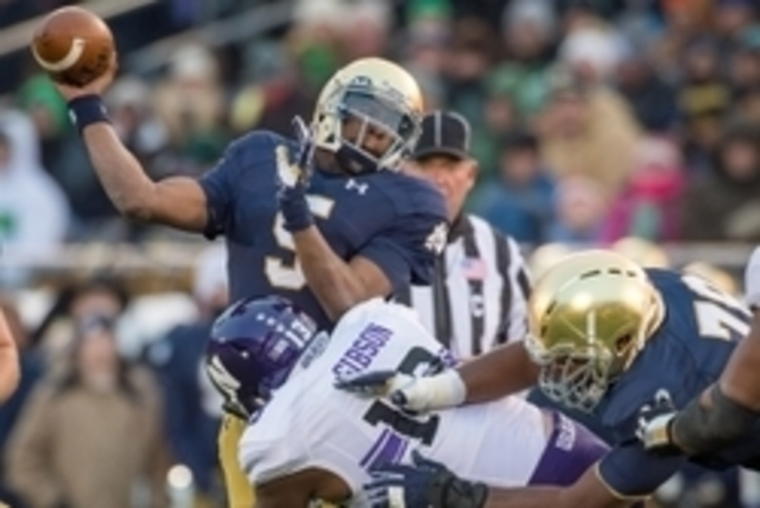 Nov 15, 2014; South Bend, IN, USA; Notre Dame Fighting Irish quarterback Everett Golson (5) is hit as he throws by Northwestern Wildcats defensive end Deonte Gibson (13) in the second quarter at Notre Dame Stadium. Mandatory Credit: Matt Cashore-USA TODAY