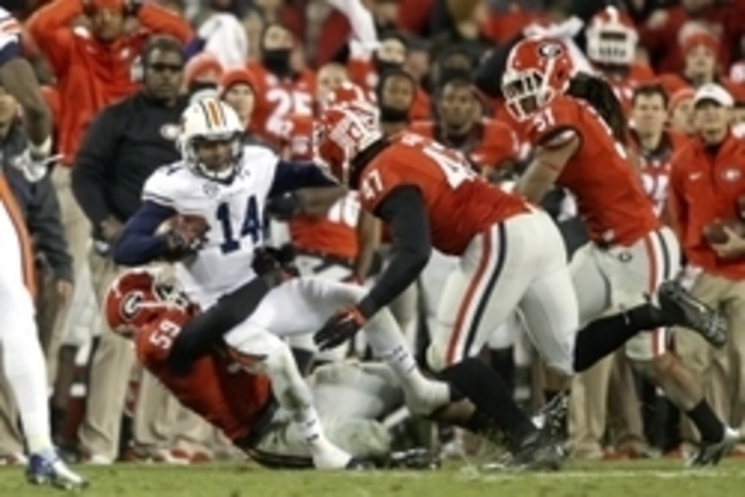 Nov 15, 2014; Athens, GA, USA; Auburn Tigers quarterback Nick Marshall (14) gets tackled by Georgia Bulldogs linebacker Jordan Jenkins (59) for a short gain as Bulldogs defensive end Ray Drew (47) and linebacker Ramik Wilson (51) pursue in the fourth quar