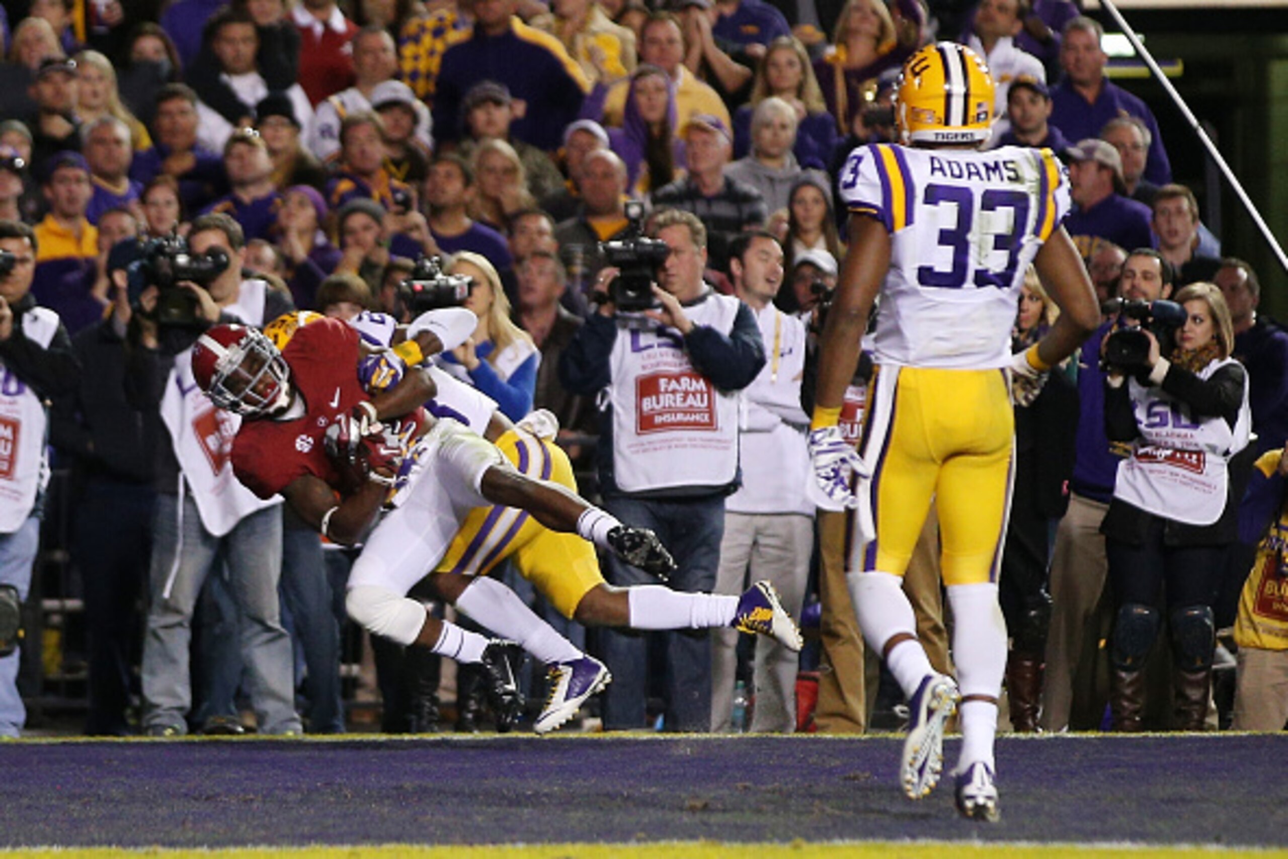 BATON ROUGE, LA - NOVEMBER 08:  DeAndrew White #2 of the Alabama Crimson Tide catches a touchdown pass in overtime as he is tackled by Jalen Mills #28 of the LSU Tigers at Tiger Stadium on November 8, 2014 in Baton Rouge, Louisiana.  (Photo by Chris Grayt