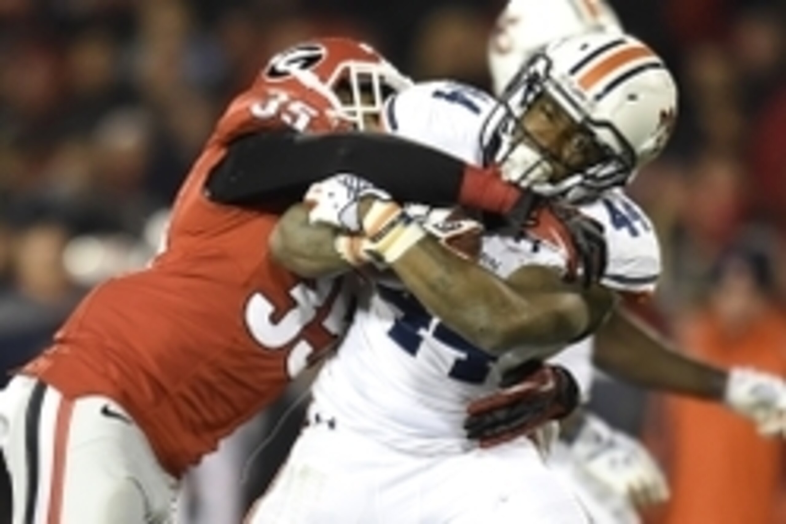 Nov 15, 2014; Athens, GA, USA; Auburn Tigers running back Cameron Artis-Payne (44) is tackled by Georgia Bulldogs cornerback Aaron Davis (35) during the second half at Sanford Stadium. Georgia defeated Auburn 34-7. Mandatory Credit: Dale Zanine-USA TODAY 