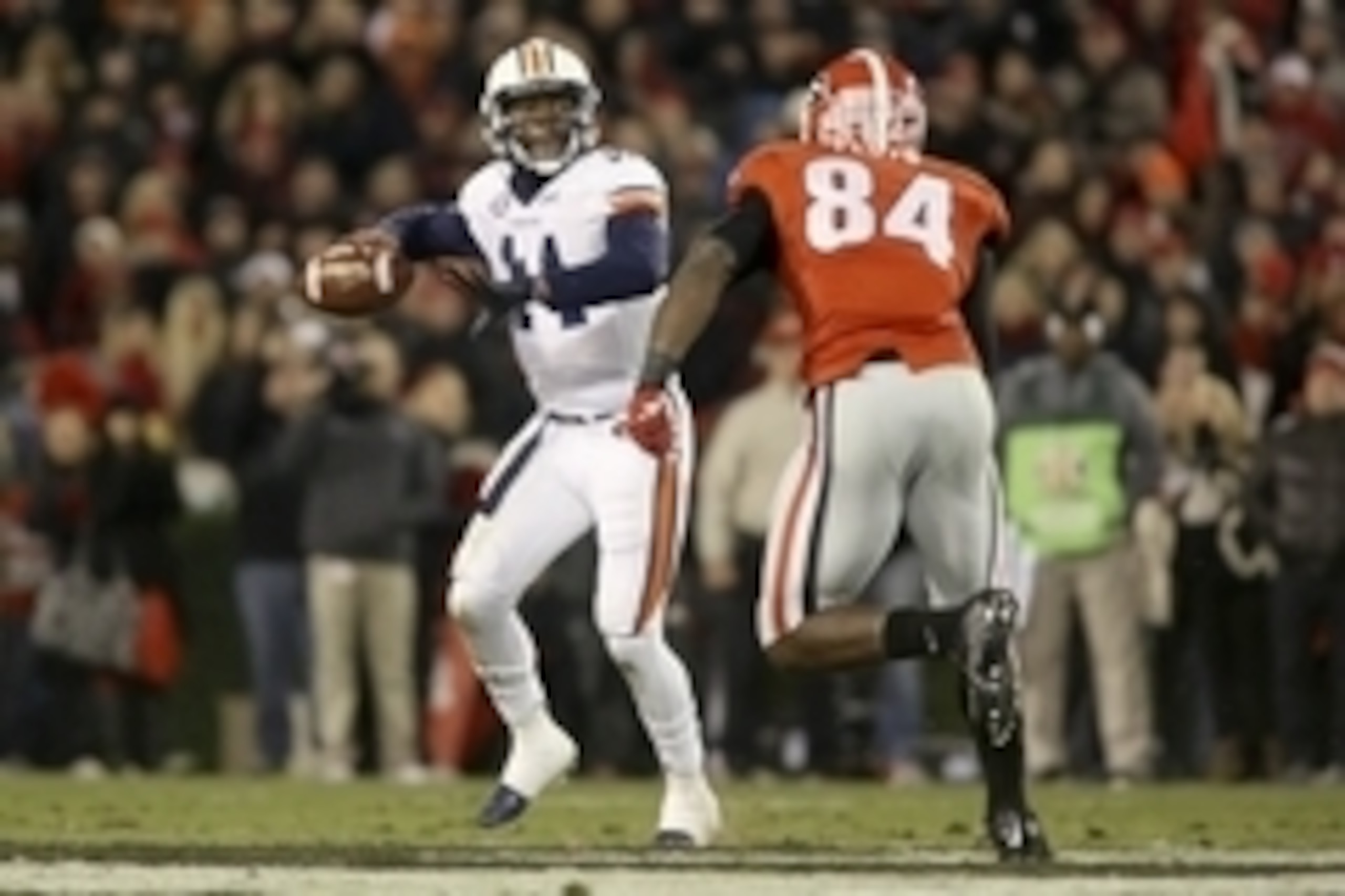 Nov 15, 2014; Athens, GA, USA; Auburn Tigers quarterback Nick Marshall (14) attempts a pass as he is pressured by Georgia Bulldogs linebacker Leonard Floyd (84) in the third quarter of their game at Sanford Stadium. Georgia won 34-7. Mandatory Credit: Jas