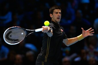 LONDON, ENGLAND - NOVEMBER 16:  Novak Djokovic of Serbia plays a forehand in the exhibition match against Andy Murray of Great Britain on day eight of the Barclays ATP World Tour Finals at O2 Arena on November 16, 2014 in London, England. The Singles fina