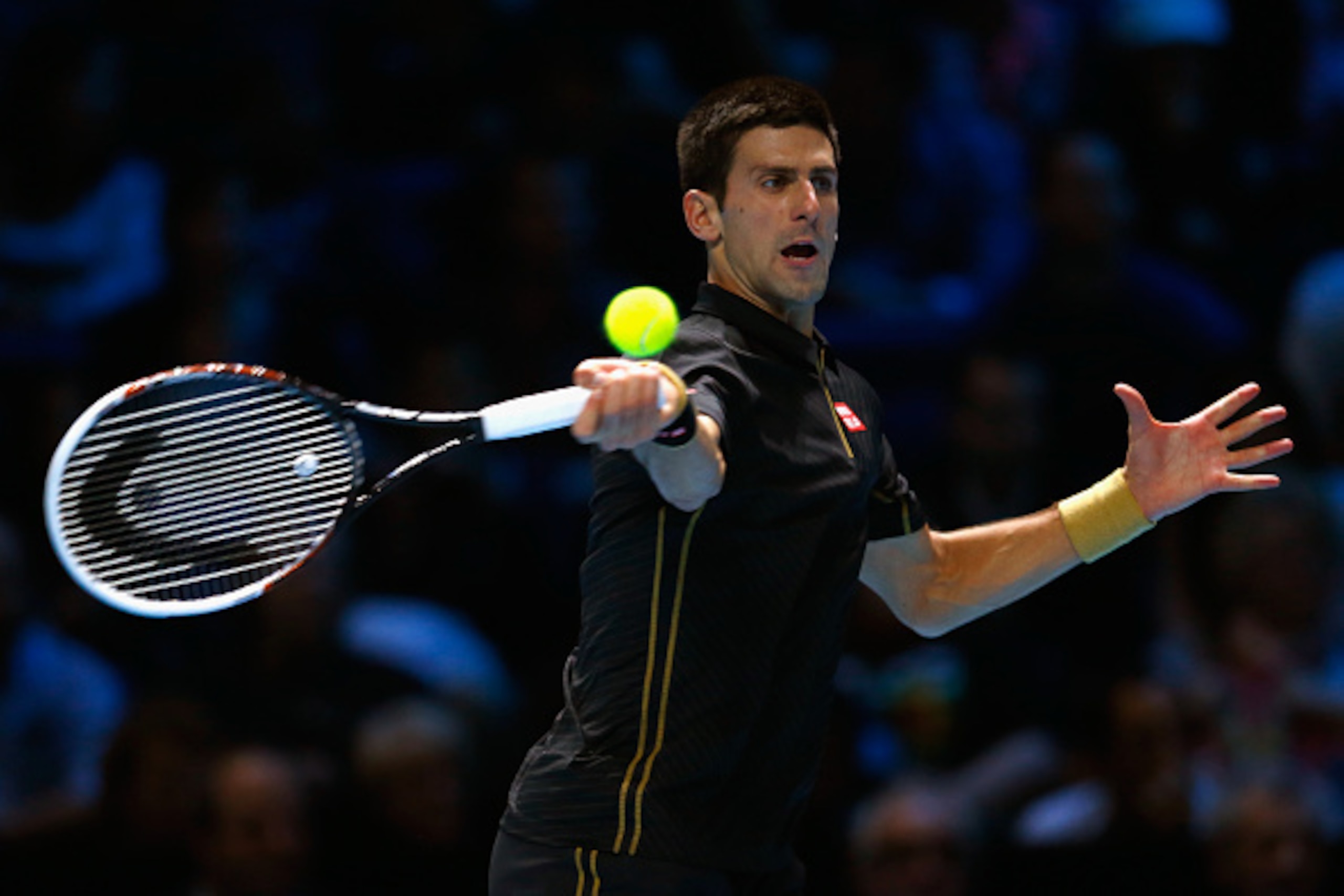 LONDON, ENGLAND - NOVEMBER 16:  Novak Djokovic of Serbia plays a forehand in the exhibition match against Andy Murray of Great Britain on day eight of the Barclays ATP World Tour Finals at O2 Arena on November 16, 2014 in London, England. The Singles fina