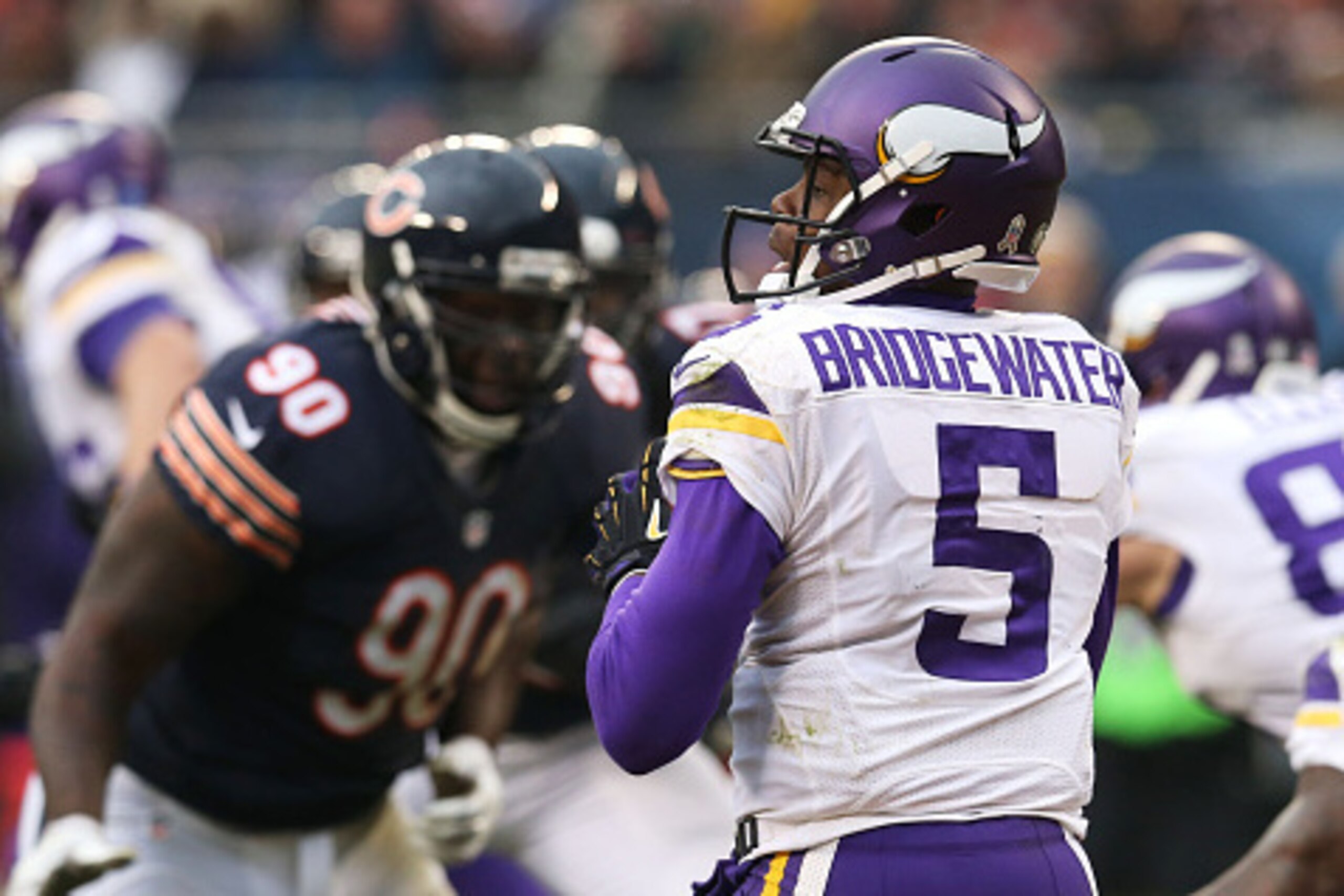 CHICAGO, IL - NOVEMBER 16: Teddy Bridgewater #5 of the Minnesota Vikings looks for a receiver during as Jeremiah Ratliff #90 of the Chicago Bears pressures during he third quarter of a game at Soldier Field on November 16, 2014 in Chicago, Illinois. The B