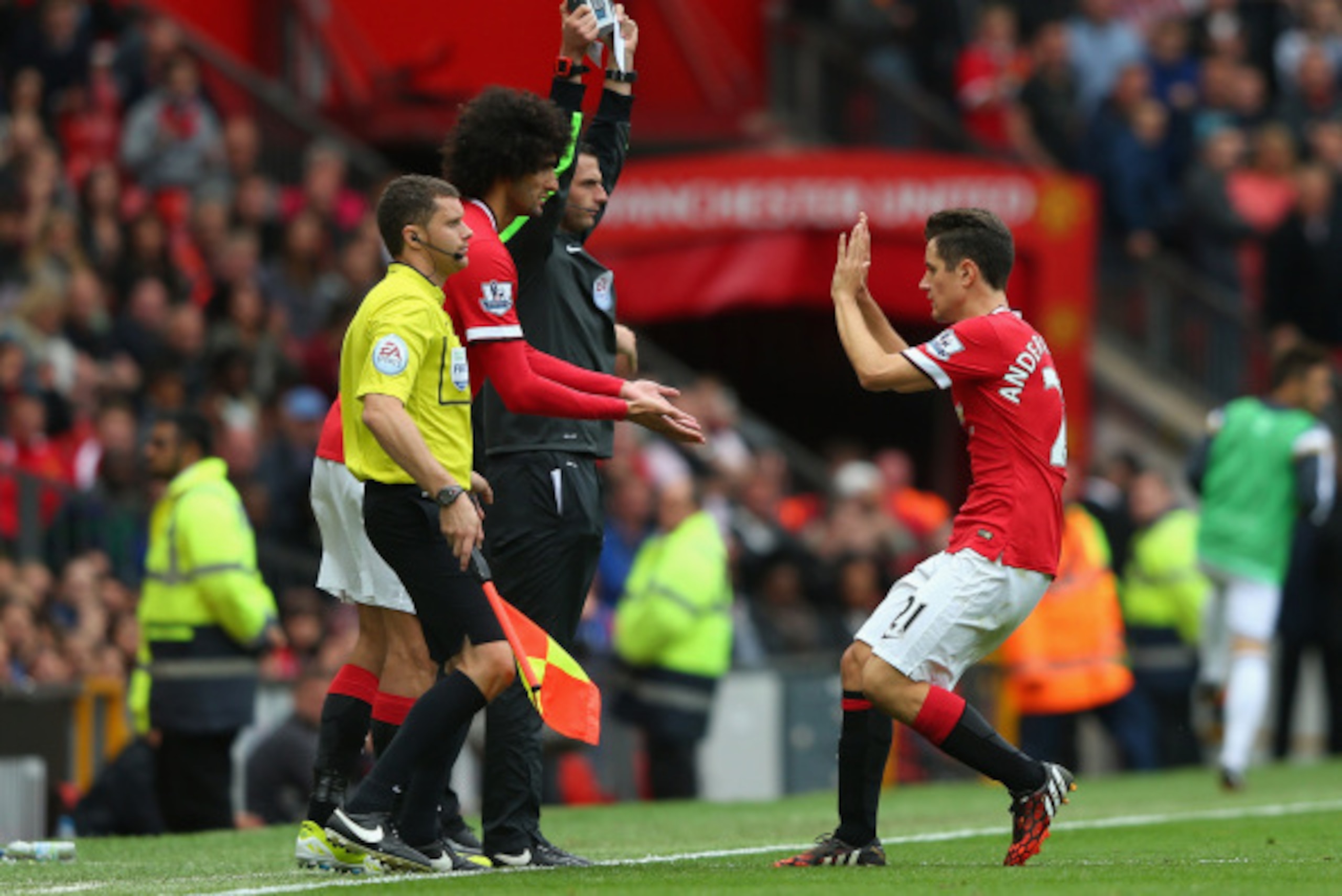 MANCHESTER, ENGLAND - AUGUST 16:  Marouane Fellaini of Manchester United replaces Ander Herrera (R) during the Barclays Premier League match between Manchester United and Swansea City at Old Trafford on August 16, 2014 in Manchester, England.  (Photo by A