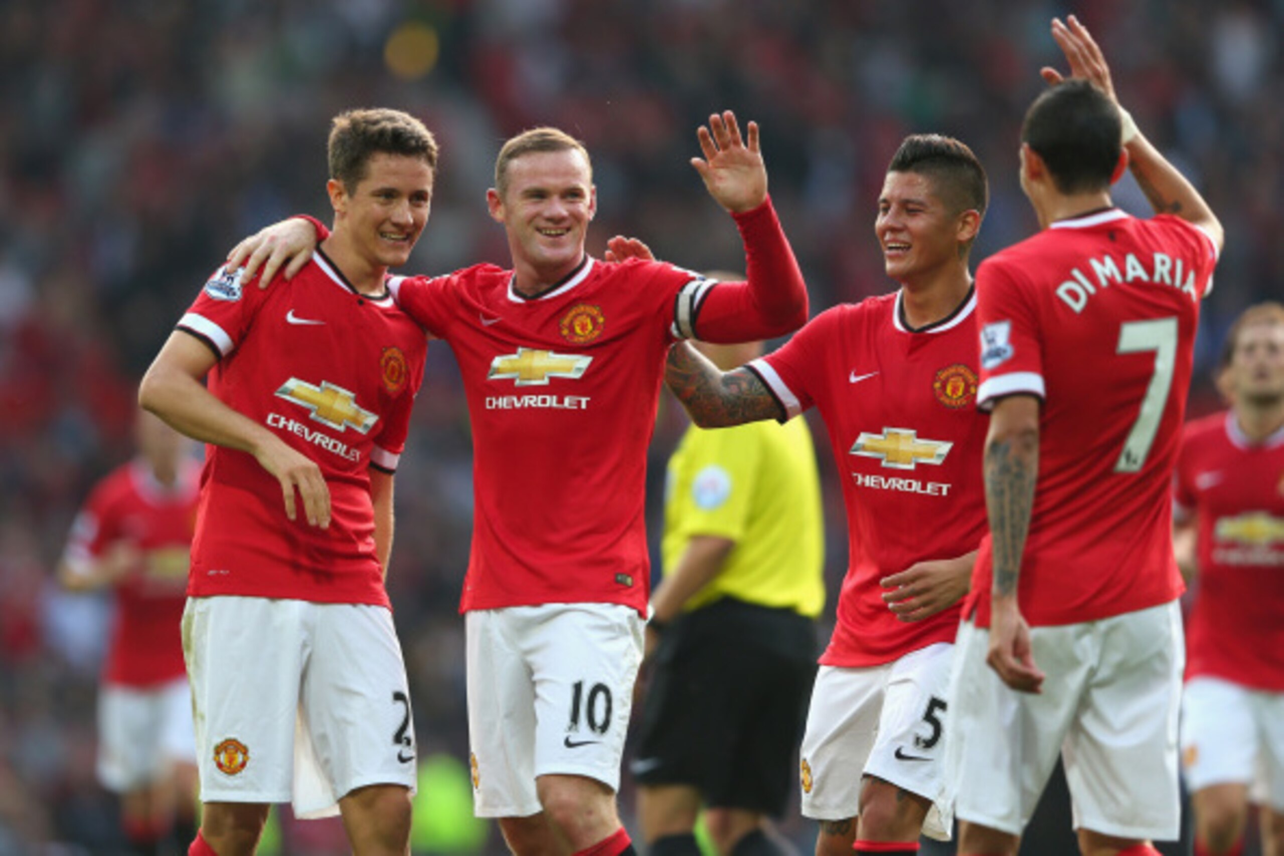 MANCHESTER, ENGLAND - SEPTEMBER 14:  Wayne Rooney of Manchester United celebrates scoring the third goal with team-mates Ander Herrera (L), Marcos Rojo and Angel Di Maria during the Barclays Premier League match between Manchester United and Queens Park R