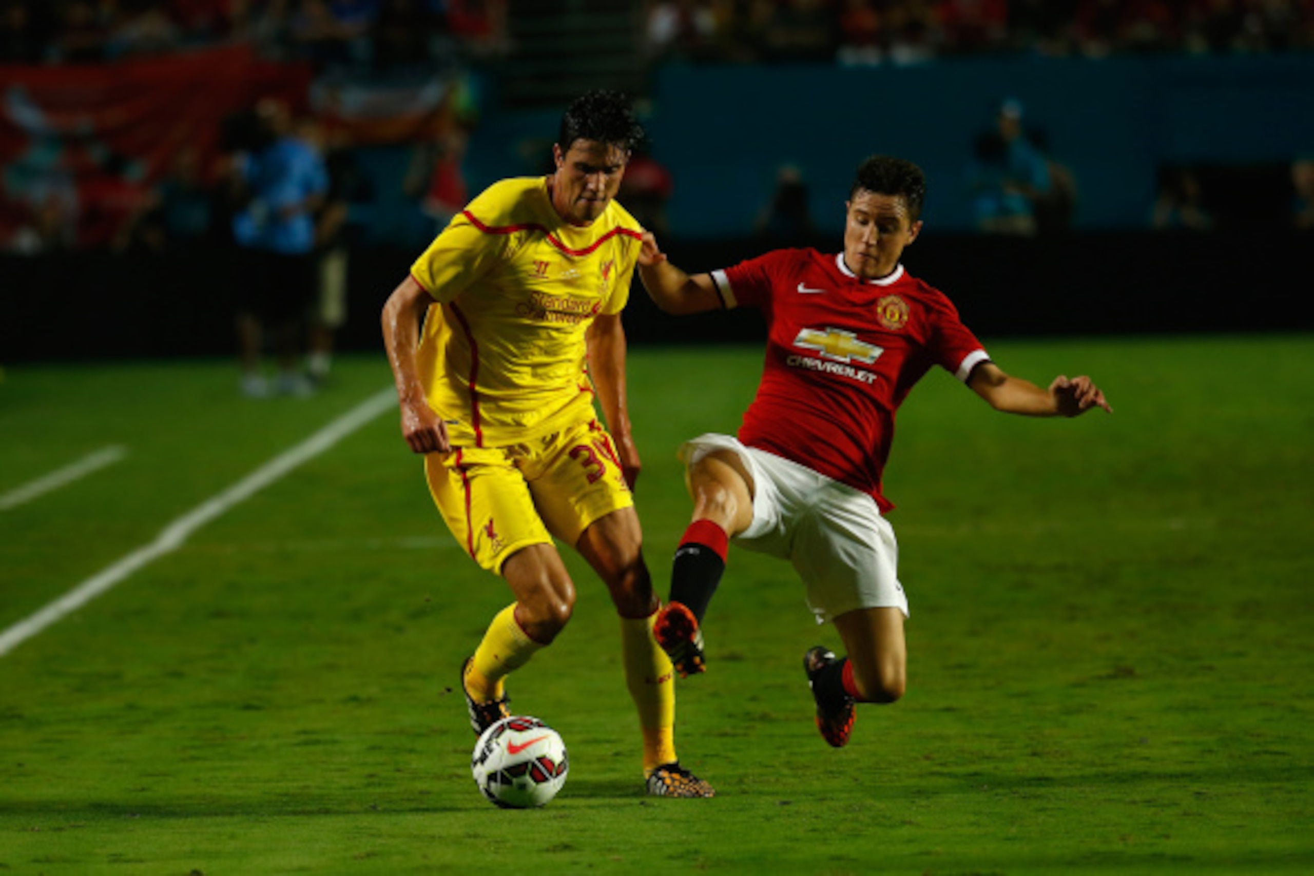 MIAMI GARDENS, FL - AUGUST 04:  (L) Jose Enrique #3 of Liverpool is challenged by (R) Ander Herrera #21 of Manchester United  in the Guinness International Champions Cup 2014 Final at Sun Life Stadium on August 4, 2014 in Miami Gardens, Florida.  (Photo b