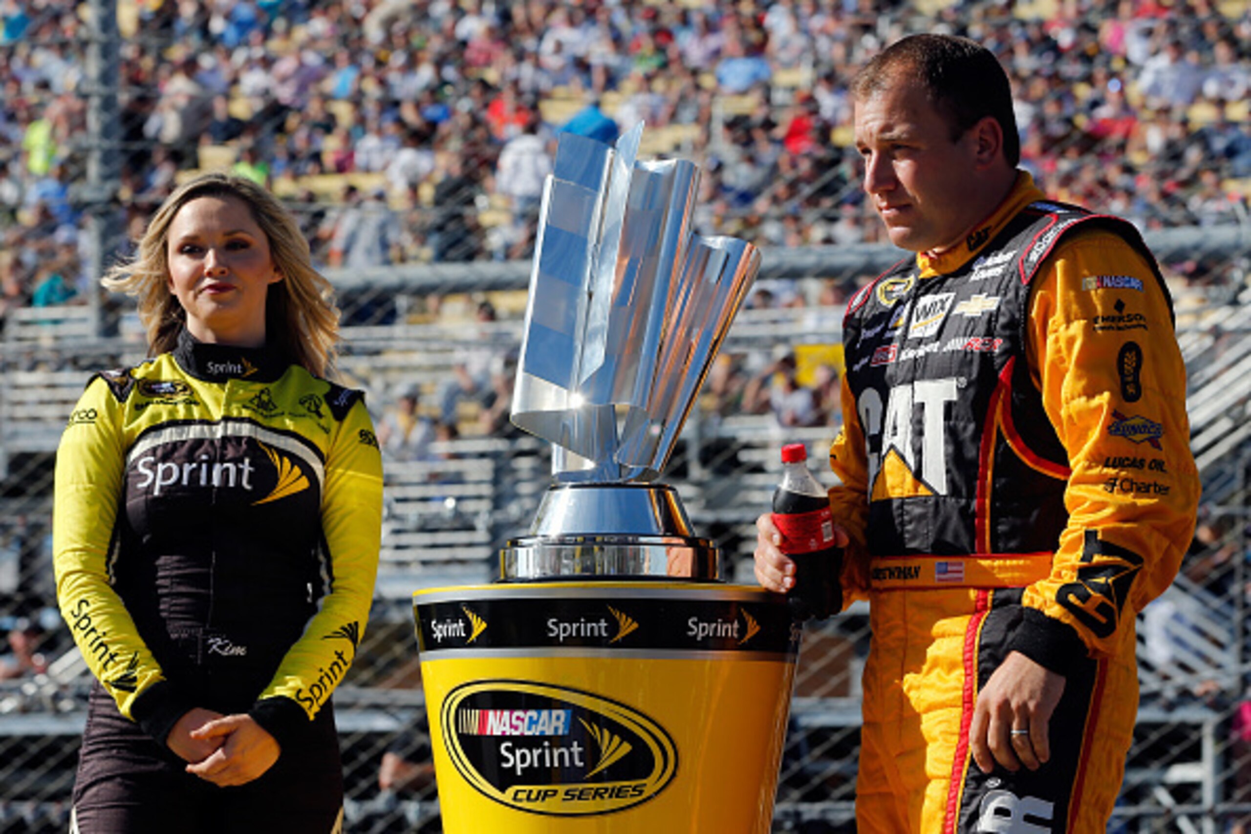 HOMESTEAD, FL - NOVEMBER 16:  Ryan Newman, driver of the #31 Caterpillar Chevrolet, stands with Miss Sprint Cup Kim Coon before the start of the NASCAR Sprint Cup Series Ford EcoBoost 400 at Homestead-Miami Speedway on November 16, 2014 in Homestead, Flor