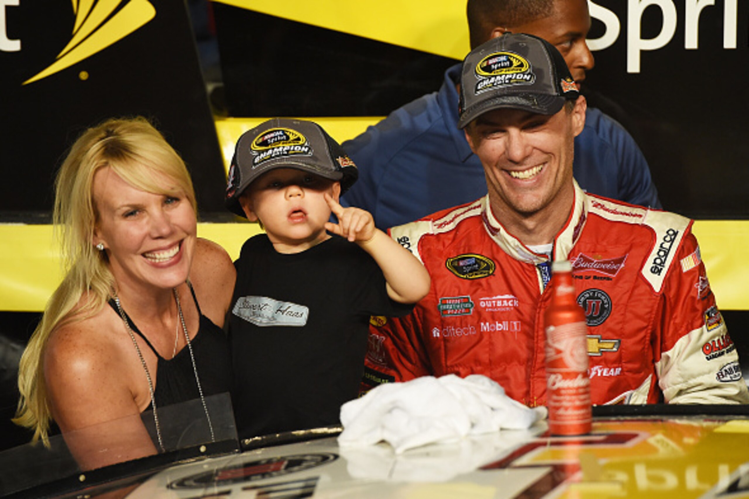 HOMESTEAD, FL - NOVEMBER 16:  Kevin Harvick, driver of the #4 Budweiser Chevrolet, celebrates with  his wife DeLana and son Keelan in victory lane after winning during the NASCAR Sprint Cup Series Ford EcoBoost 400 at Homestead-Miami Speedway on November 