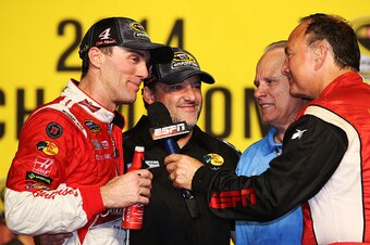 HOMESTEAD, FL - NOVEMBER 16:  Kevin Harvick, driver of the #4 Budweiser Chevrolet, and team owner Tony Stewart are interviewed in Victory Lane after winning the NASCAR Sprint Cup Series Ford EcoBoost 400 at Homestead-Miami Speedway on November 16, 2014 in