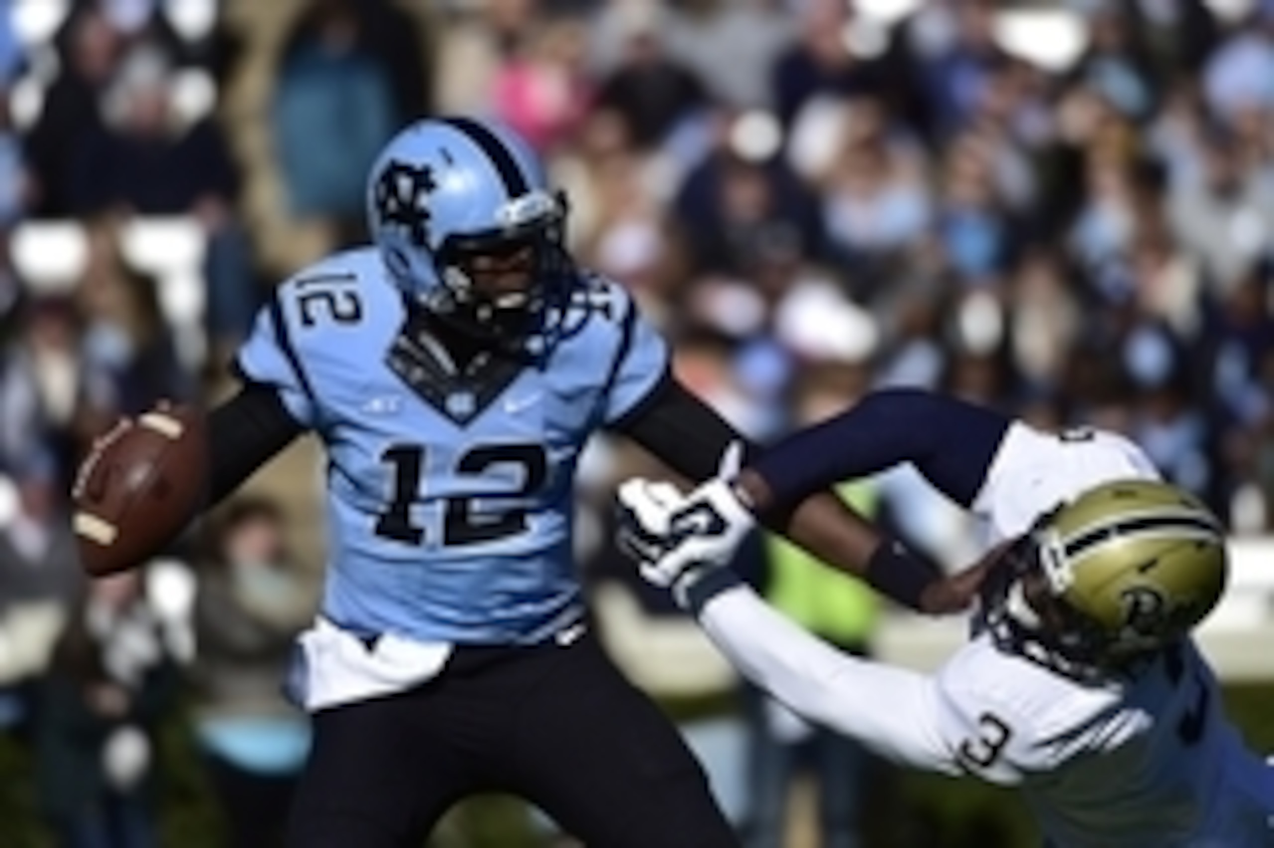 Nov 15, 2014; Chapel Hill, NC, USA; North Carolina Tar Heels quarterback Marquise Williams (12) looks to pass as Pittsburgh Panthers linebacker Nicholas Grigsby (3) pressures in the second quarter at Kenan Memorial Stadium. Mandatory Credit: Bob Donnan-US