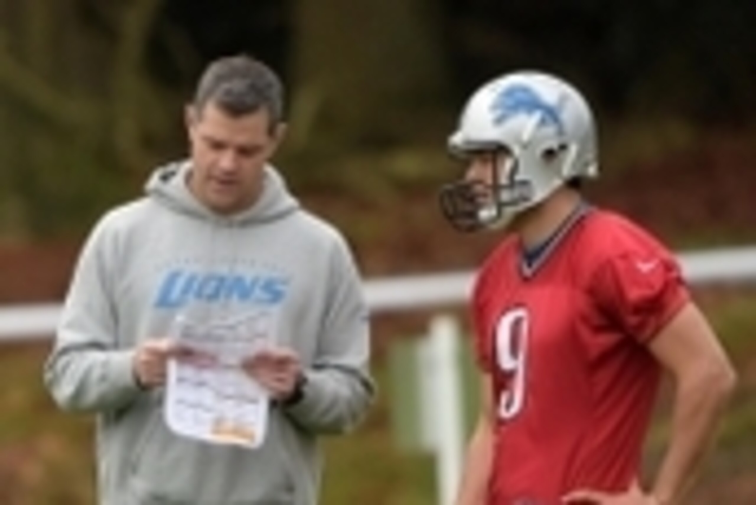 Oct 24, 2014; Bagshot, UNITED KINGDOM; Detroit Lions offensive coordinator Joe Lombardi (left) and quarterback Matthew Stafford (9) at practice at the Pennyhill Park Hotel & The Spa in advance of the NFL International Series game against the Atlanta Falco