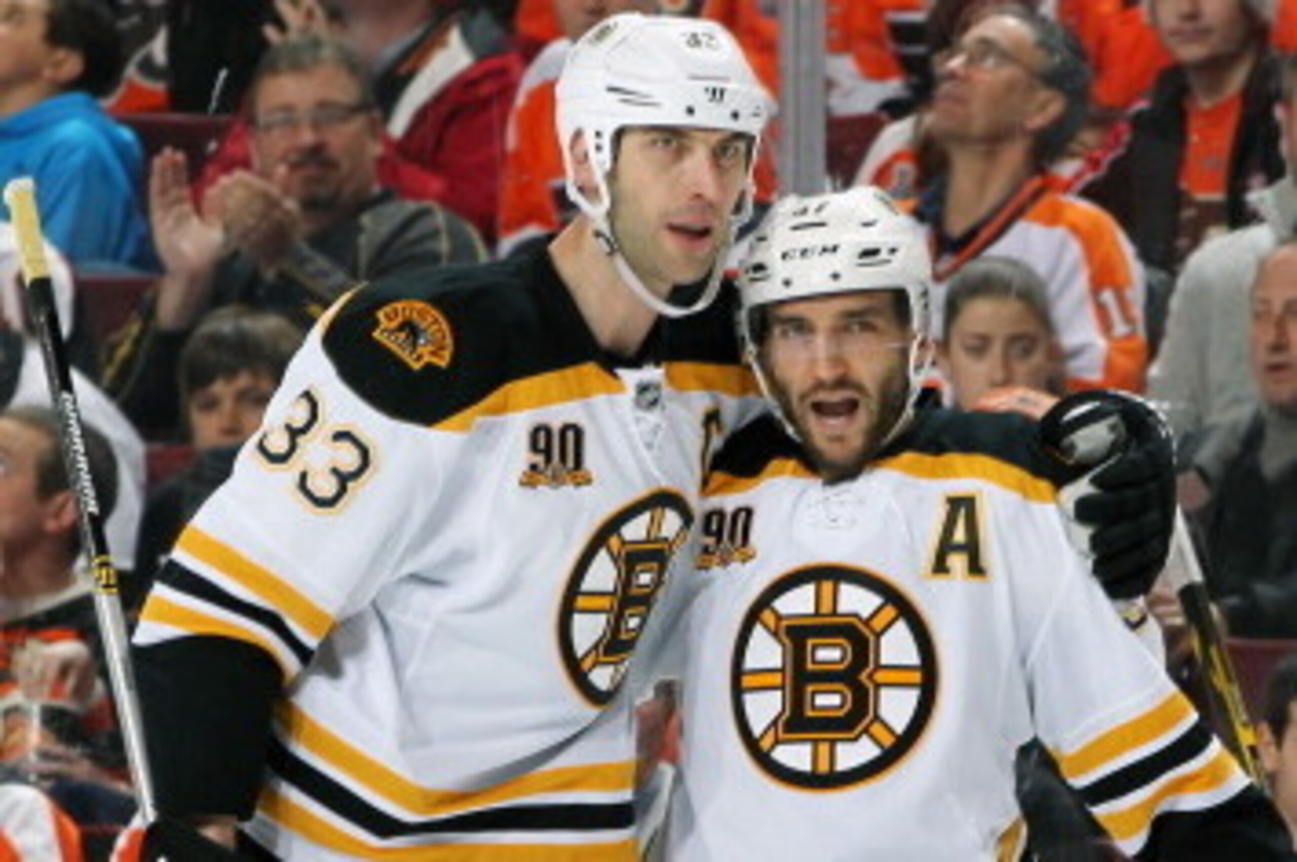 PHILADELPHIA, PA - MARCH 30: Patrice Bergeron #37 of the Boston Bruins celebrates his second period goal against the Philadelphia Flyers with teammates Zdeno Chara #33 and Reilly Smith #18 on March 30, 2014 at the Wells Fargo Center in Philadelphia, Penns