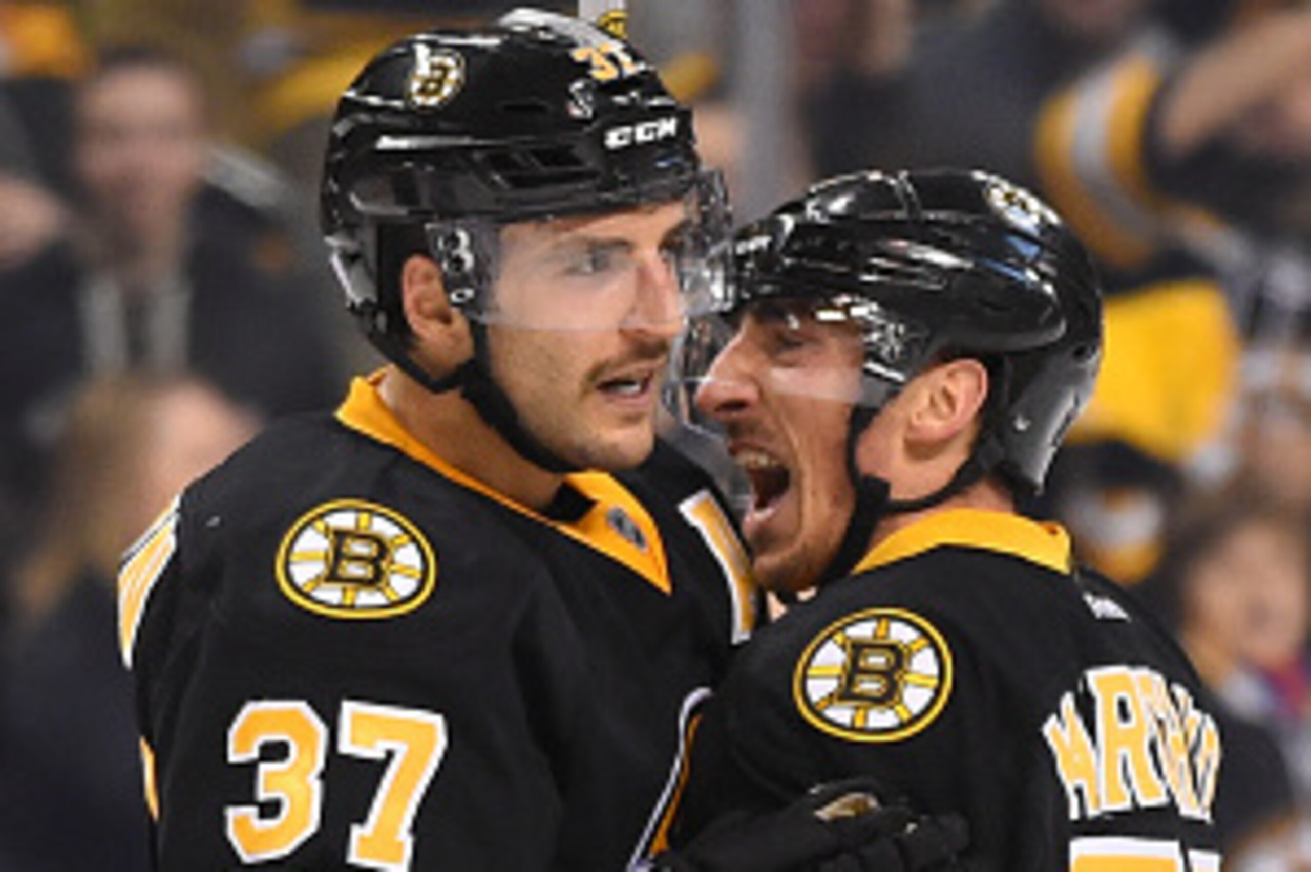 BOSTON, MA - NOVEMBER 15 : Patrice Bergeron #37 and Brad Marchand #63 of the Boston Bruins celebrate a goal against the Carolina Hurricanes at the TD Garden on November 15, 2014 in Boston, Massachusetts.  (Photo by Brian Babineau/NHLI via Getty Images)