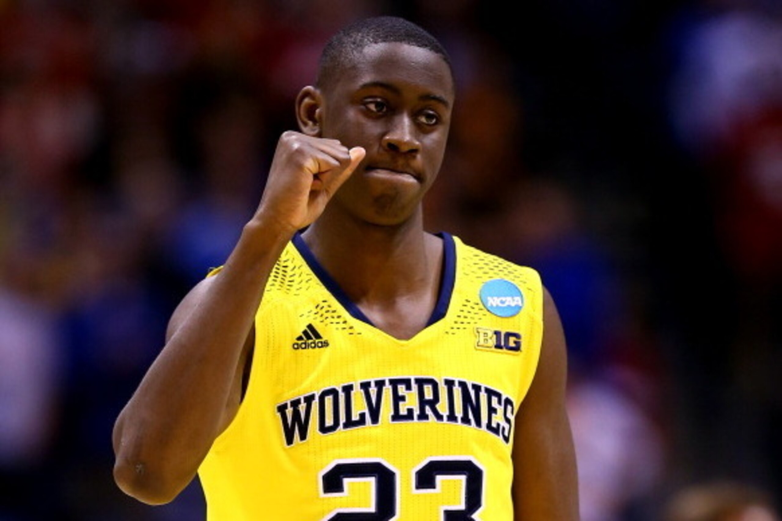 INDIANAPOLIS, IN - MARCH 28:  Caris LeVert #23 of the Michigan Wolverines celebrates defeating the Tennessee Volunteers 73 to 71 during the regional semifinal of the 2014 NCAA Men's Basketball Tournament at Lucas Oil Stadium on March 28, 2014 in Indianapo