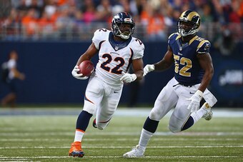 ST. LOUIS, MO - NOVEMBER 16: C.J. Anderson #22 of the Denver Broncos avoids Alec Ogletree #52 of the St. Louis Rams after making a catch in the second quarter at the Edward Jones Dome on November 16, 2014 in St. Louis, Missouri.  The Rams beat the Broncos