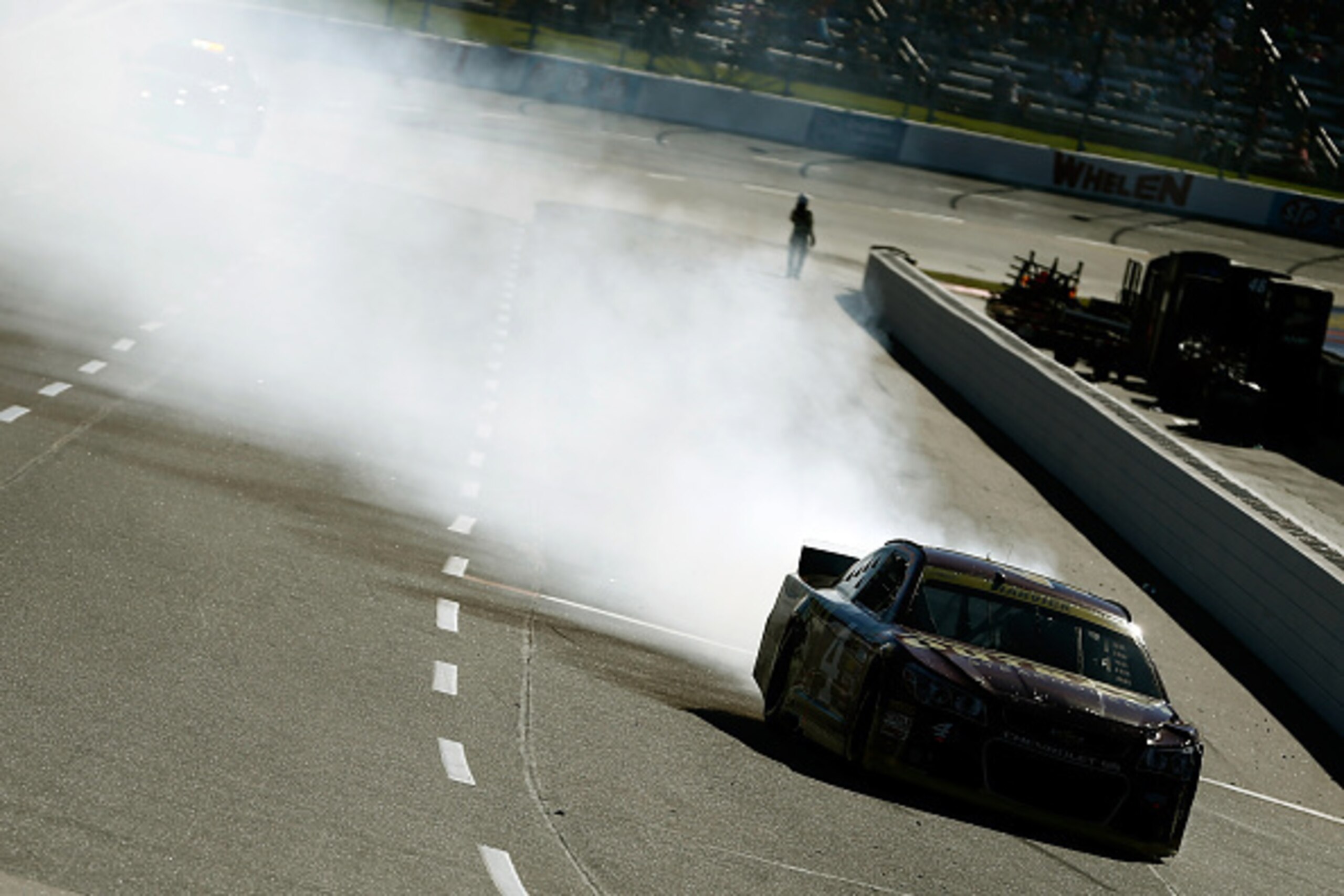 MARTINSVILLE, VA - OCTOBER 26:  Kevin Harvick, driver of the #4 Outback Steakhouse Chevrolet, drives to the pits with smoke pouring from his car during the NASCAR Sprint Cup Series Goody's Headache Relief Shot 500 at Martinsville Speedway on October 26, 2