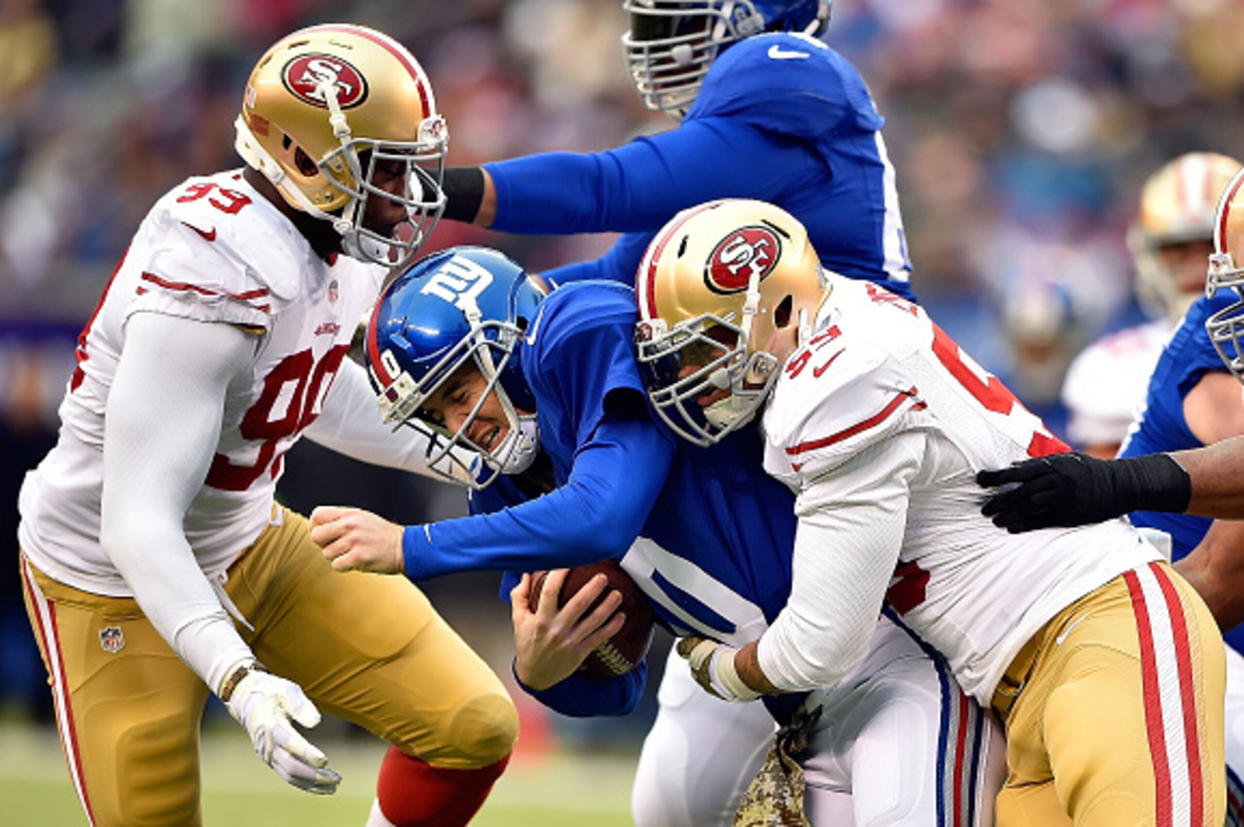 EAST RUTHERFORD, NJ - NOVEMBER 16:  (R-L) Aaron Lynch #59 and  Aldon Smith #99 of the San Francisco 49ers sack  Eli Manning #10 of the New York Giants  at MetLife Stadium on November 16, 2014 in East Rutherford, New Jersey.  (Photo by Al Bello/Getty Image