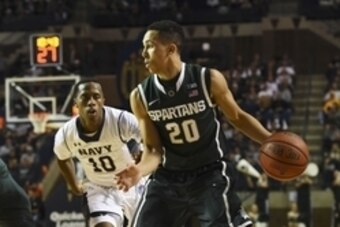 Nov 14, 2014; Annapolis, MD, USA; Michigan State Spartans guard Travis Trice (20) looks to pass as Navy Midshipmen guard Tilman Dunbar (10) defends during the first half at Alumni Hall. Mandatory Credit: Tommy Gilligan-USA TODAY Sports