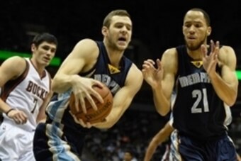 Nov 8, 2014; Milwaukee, WI, USA;  Memphis Grizzlies forward Jon Leuer (30) grabs a rebound with help from forward Tayshaun Prince (21) against Milwaukee Bucks forward Ersan Ilyasova (7) in the first quarter at BMO Harris Bradley Center. Mandatory Credit: