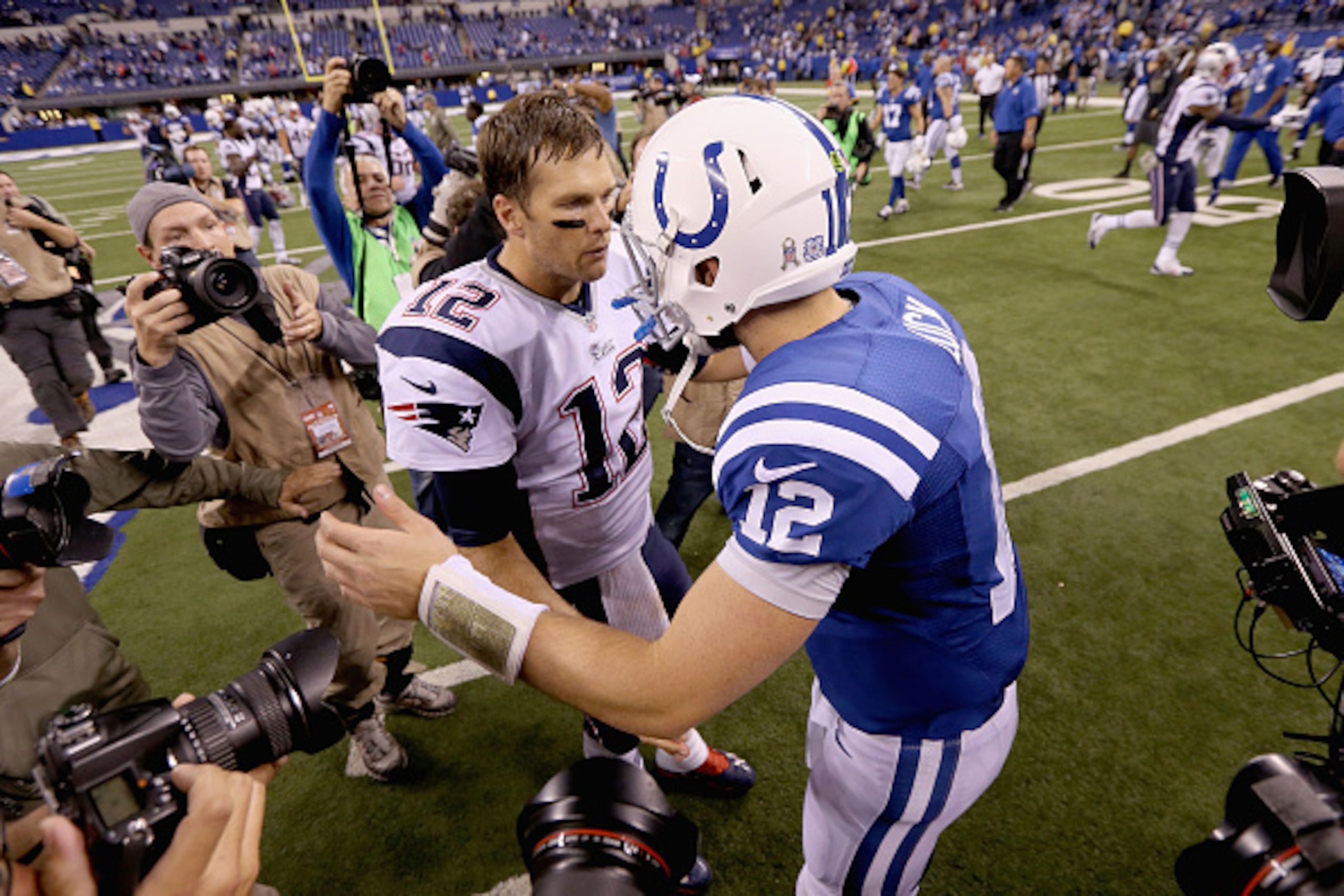 INDIANAPOLIS, IN - NOVEMBER 16:  Tom Brady #12 of the New England Patriots and Andrew Luck #12 of the Indianapolis Colts meet after the game at Lucas Oil Stadium on November 16, 2014 in Indianapolis, Indiana.  (Photo by Andy Lyons/Getty Images)