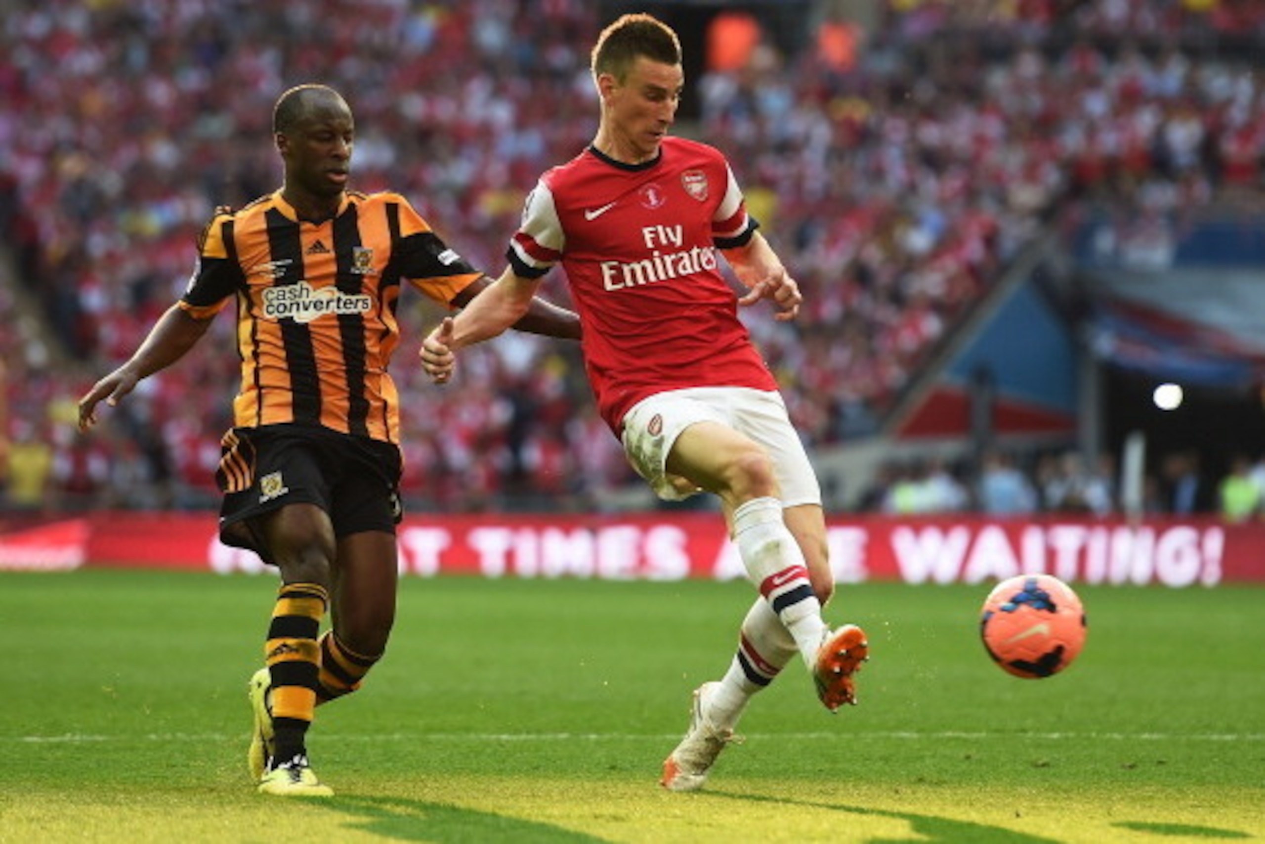 LONDON, ENGLAND - MAY 17:  Laurent Koscielny of Arsenal clears the ball from Sone Aluko of Hull City  during the FA Cup with Budweiser Final match between Arsenal and Hull City at Wembley Stadium on May 17, 2014 in London, England.  (Photo by Shaun Botter