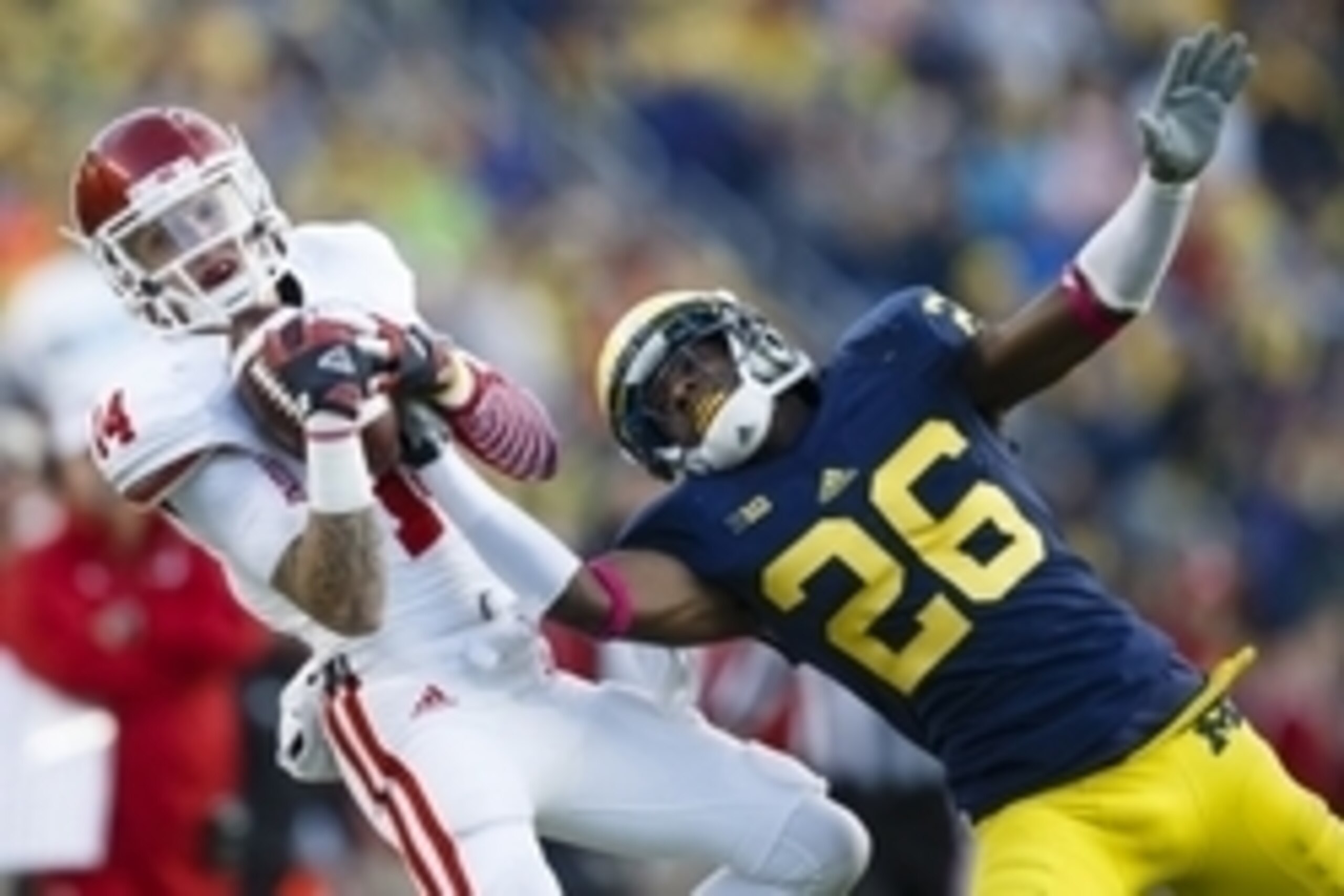 Oct 19, 2013; Ann Arbor, MI, USA; Indiana Hoosiers wide receiver Nick Stoner (14) makes a catch over Michigan Wolverines defensive back Jourdan Lewis (26) in the second half at Michigan Stadium. Michigan won 63-47. Mandatory Credit: Rick Osentoski-USA TOD