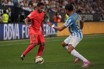 MALAGA, SPAIN - SEPTEMBER 24:  Douglas of Barcelona and Miguel Torres of Malaga compete for the ball during the La Liga match between Malaga CF and FC Barcelona at La Rosaleda studium on September 24, 2014 in Malaga, Spain. (Photo by Sergio Camacho/Getty 