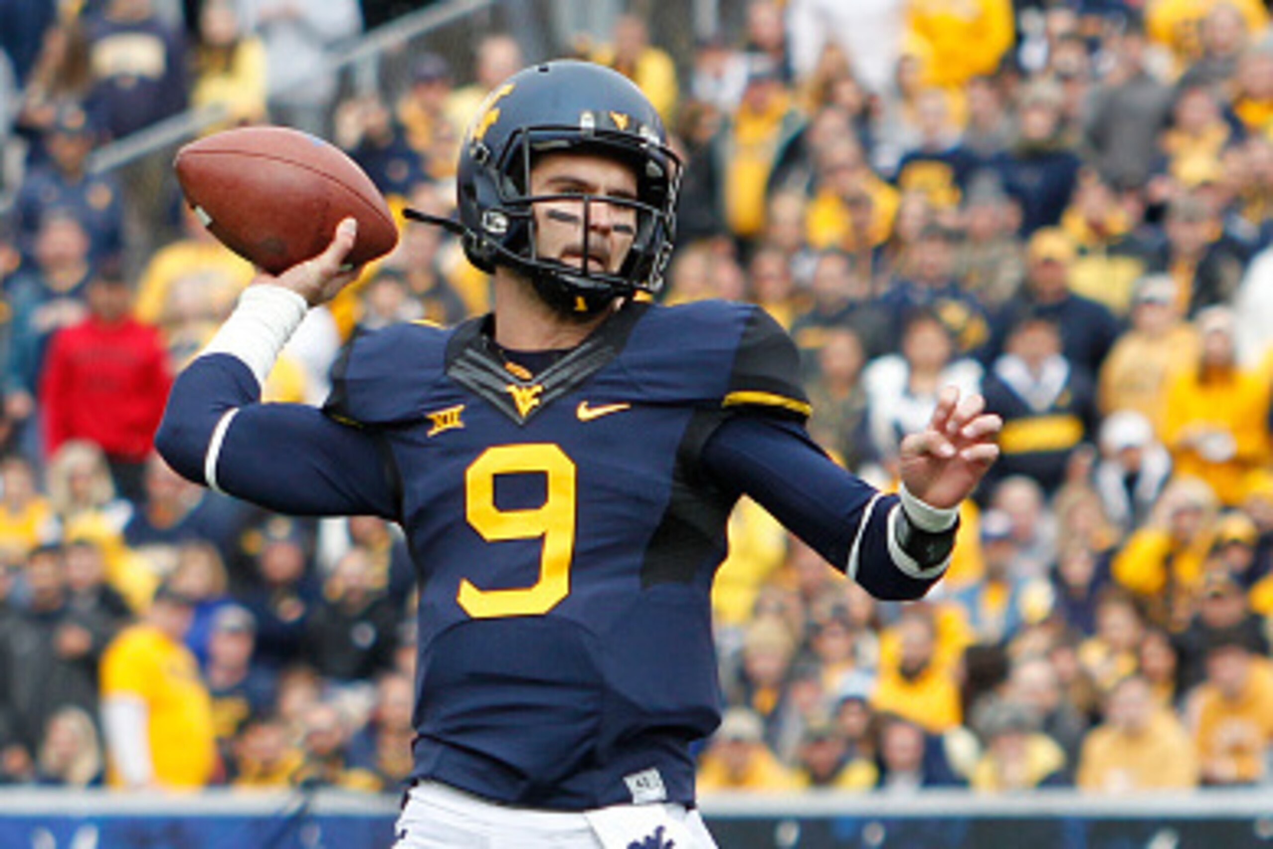 MORGANTOWN, WV - OCTOBER 18:  Clint Trickett #9 of the West Virginia Mountaineers rolls out to pass during the game against the Baylor Bears on October 18, 2014 at Mountaineer Field in Morgantown, West Virginia.  (Photo by Justin K. Aller/Getty Images)