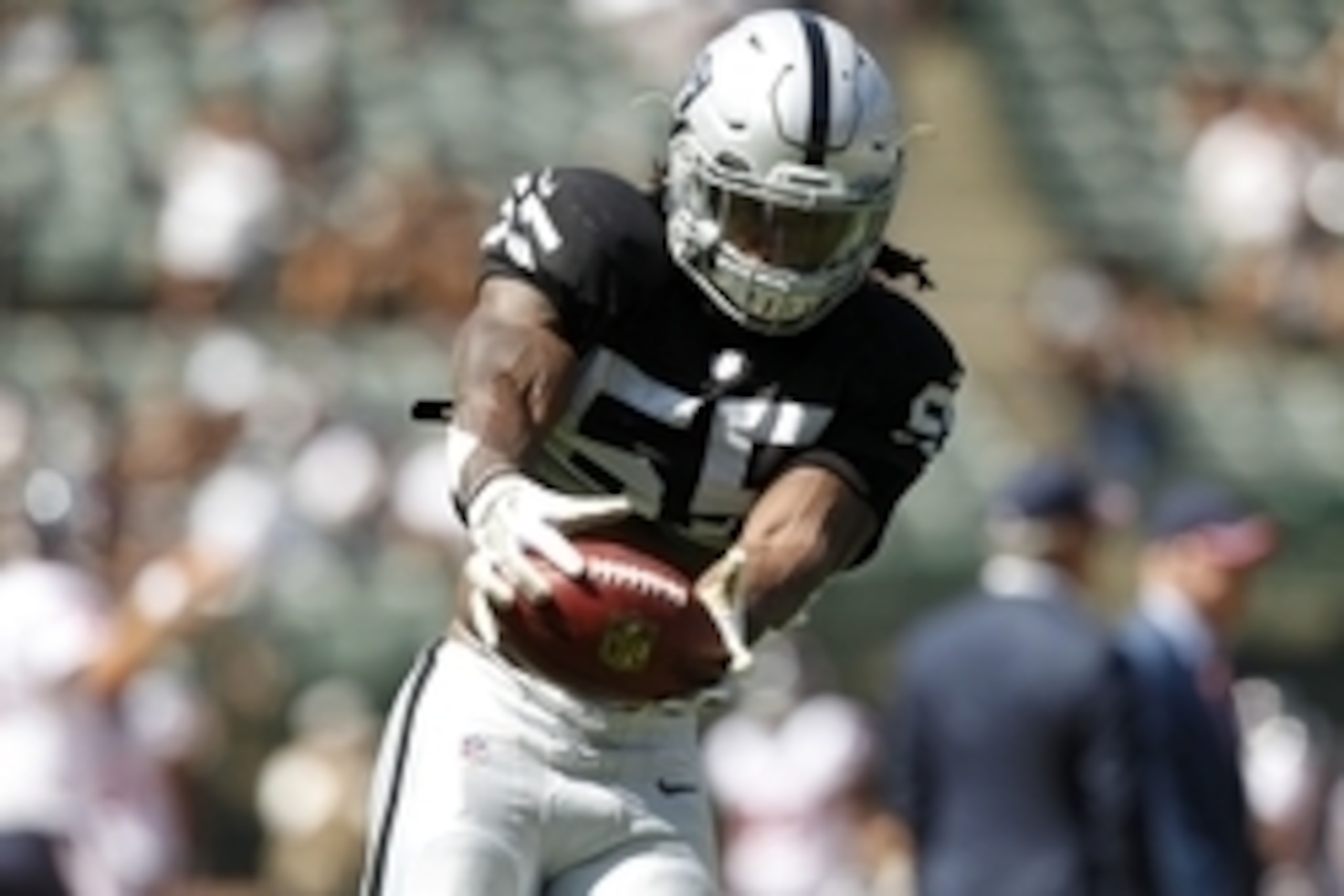 Sep 14, 2014; Oakland, CA, USA; Oakland Raiders outside linebacker Sio Moore (55) catches the ball before the start of the game against the Houston Texans at O.co Coliseum. Mandatory Credit: Cary Edmondson-USA TODAY Sports