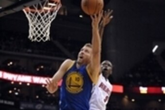 Oct 17, 2014; Kansas City, MO, USA; Golden State Warriors forward David Lee (10) shoots as Miami Heat forward Luol Deng (9) attempts to block during the first half at Sprint Center. Mandatory Credit: Denny Medley-USA TODAY Sports